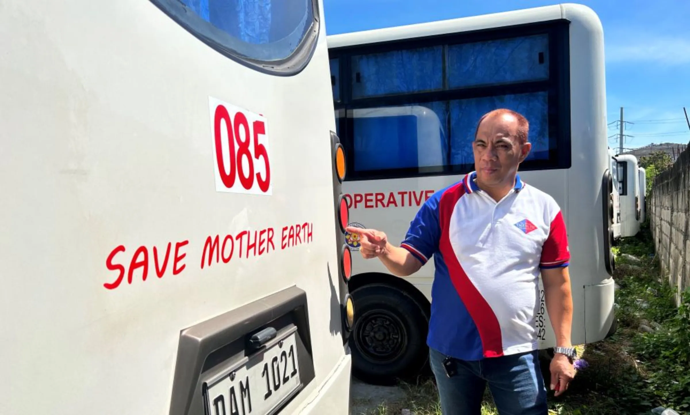 Freddie Hernandez, the head of a transport cooperative, poses with imported minibuses bought to replace traditional Jeepneys in Metro Manila, the Philippines, on February 17, 2023