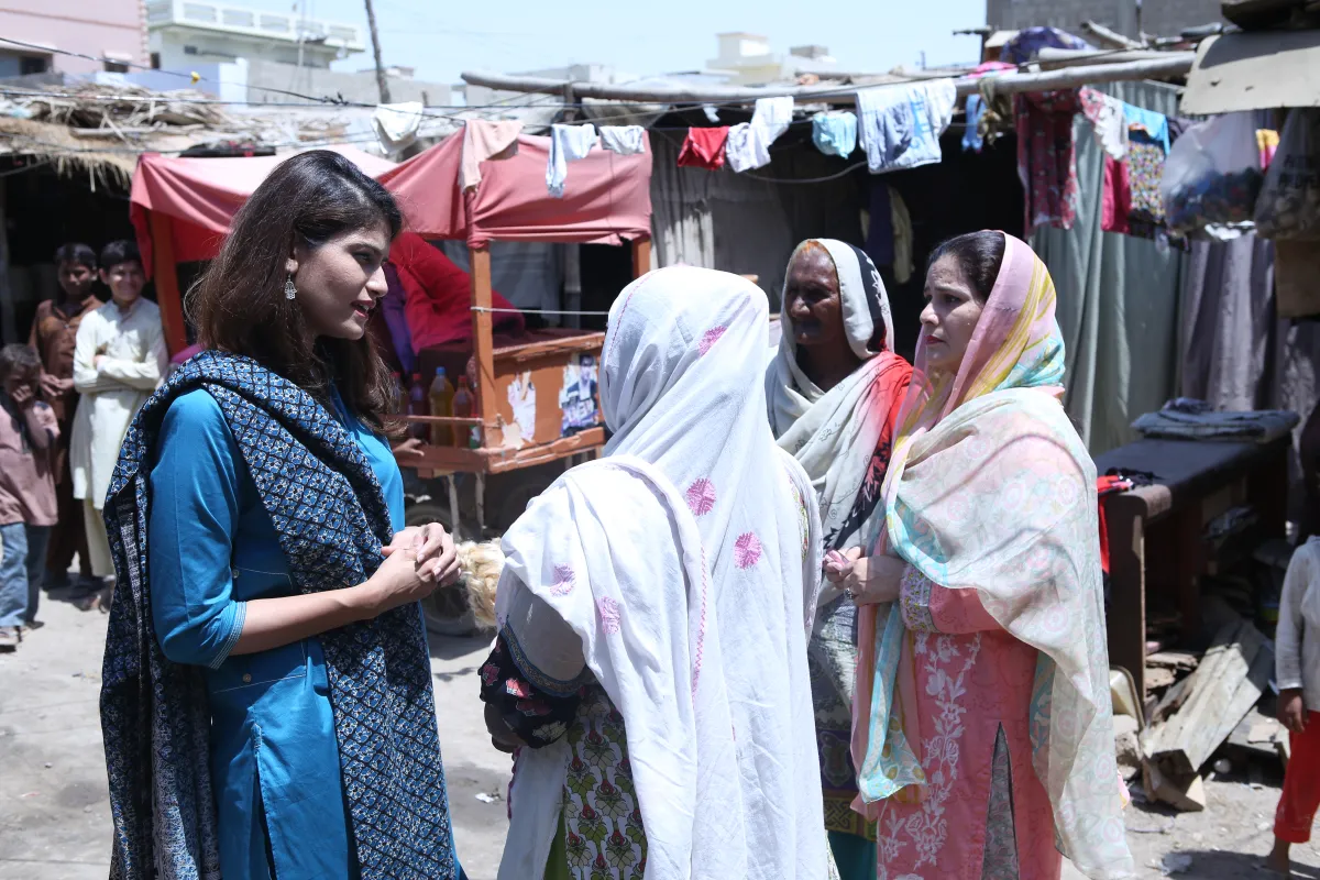 Sara Saeed Khurrum talks to patients near a Sehat Kahani telemedicine clinic in Model Colon