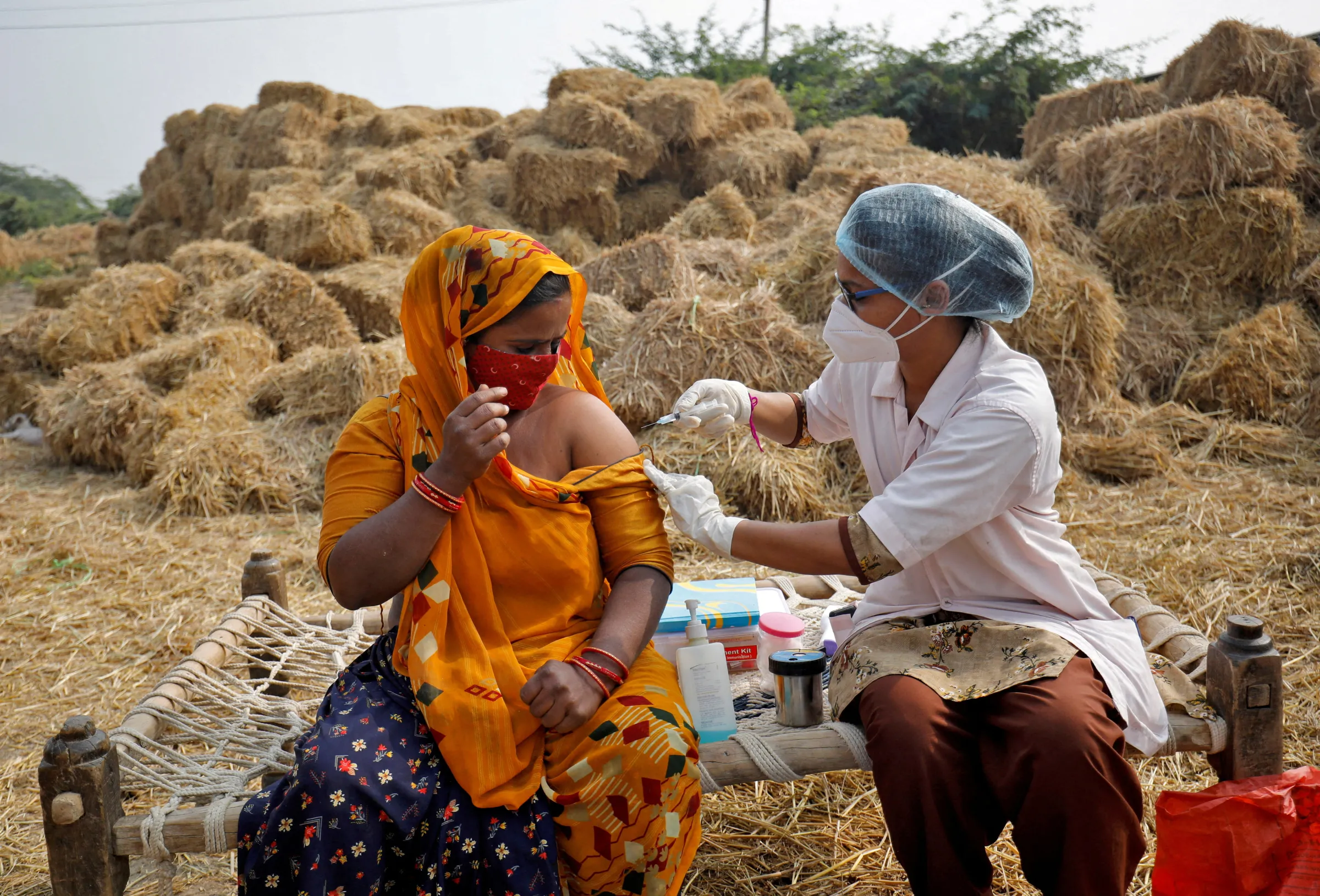 Woman receives a dose of COVISHIELD vaccine against COVID-19 on the outskirts of Ahmedabad, India, December 15, 2021. REUTERS/Amit Dave