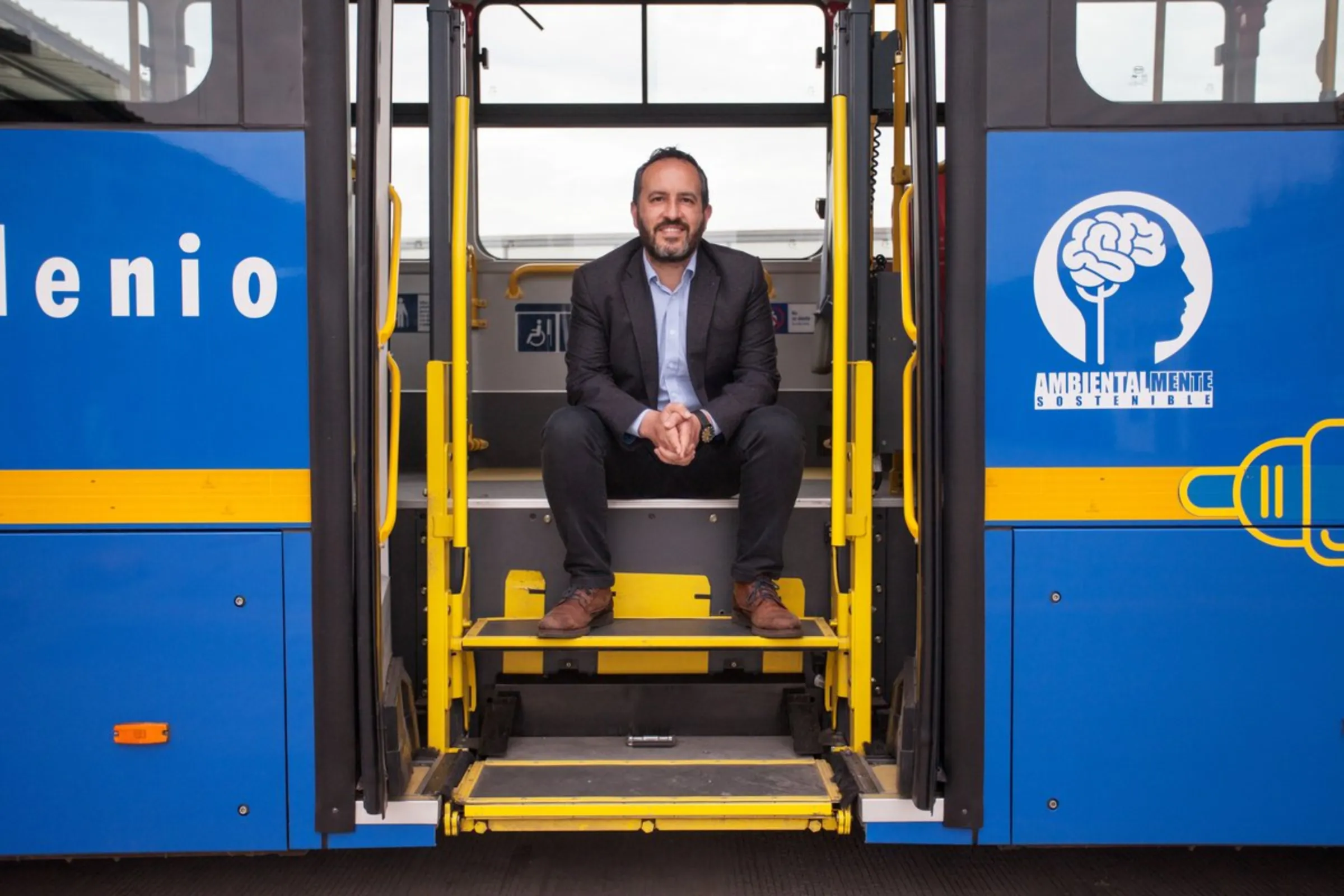 Felipe Ramirez, head of Bogota’s Transmilenio bus system, sits inside the door of an electric bus in Bogota, Colombia, April 21, 2021. About 350 electric buses now operate in the capital, with plans for 1,485 by 2022