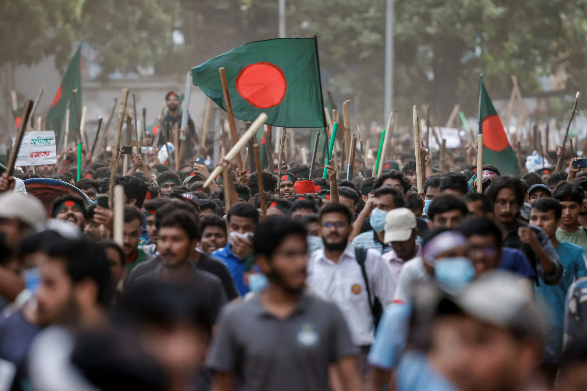 Anti-quota protesters march with Bangladeshi flags and sticks, at the University of Dhaka, in Dhaka, Bangladesh, July 16, 2024. REUTERS/Mohammad Ponir Hossain
