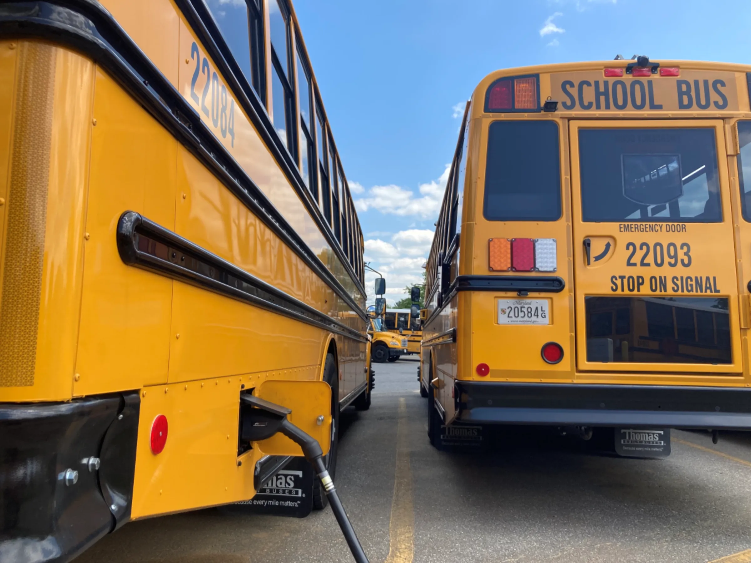 An electric school bus charges at a county facility in Rockville, Maryland, in April 2023. Thomson Reuters Foundation/Carey L. Biron