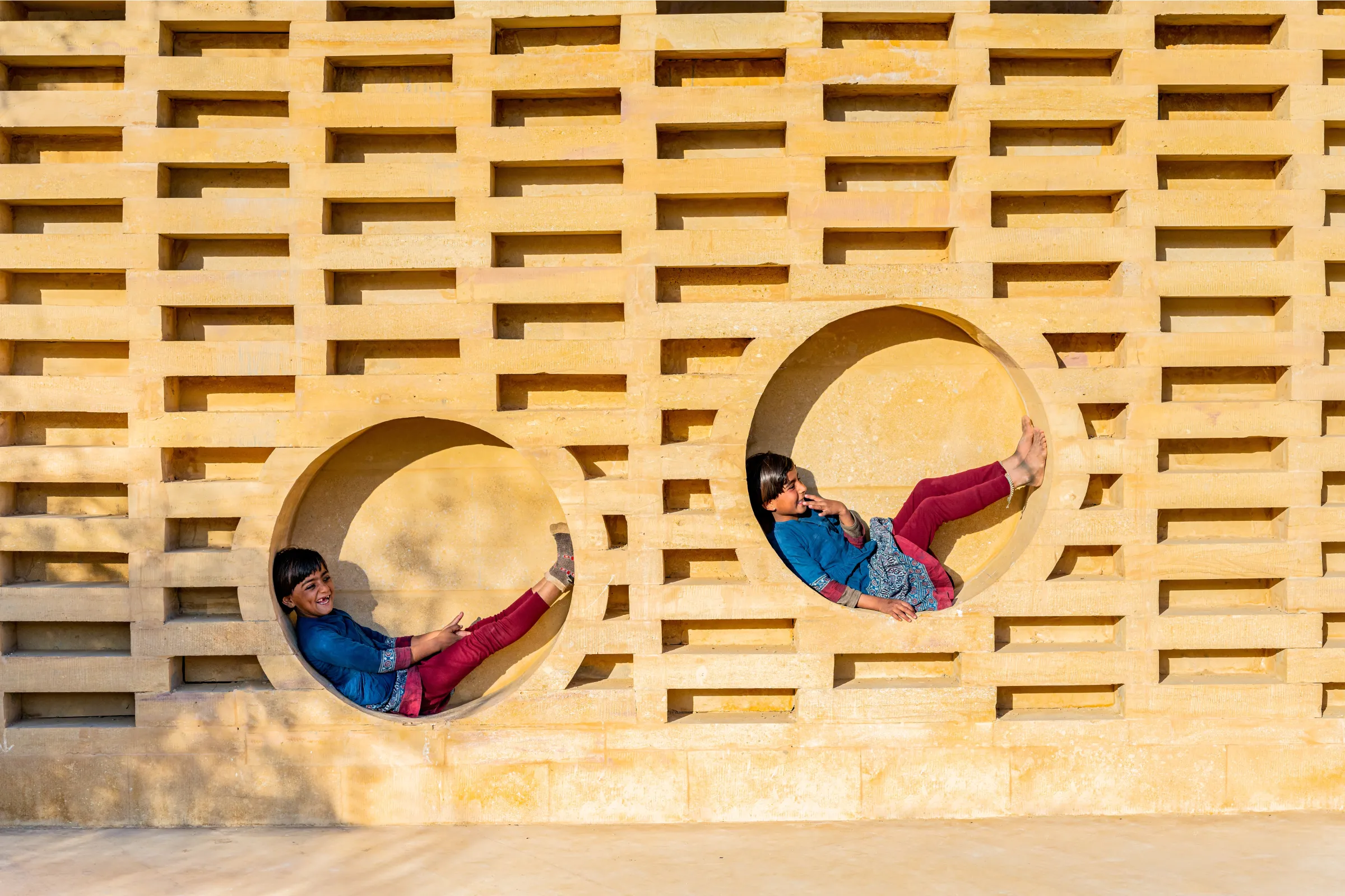 Two girls play at the Rajkumari Ratnavati Girls School. Photo taken 2021 by Vinay Panjwani. Diana Kellogg Architects/Handout via Thomson Reuters Foundation