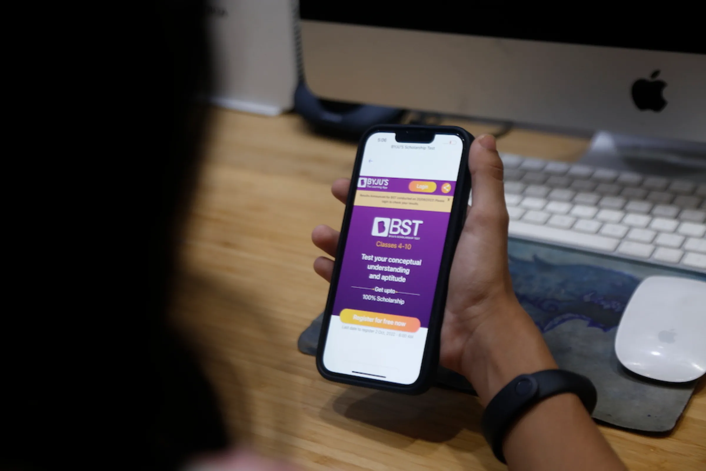 A girl looks at a page on the Byju's learning app on a mobile phone in Noida, India on October 18, 2022