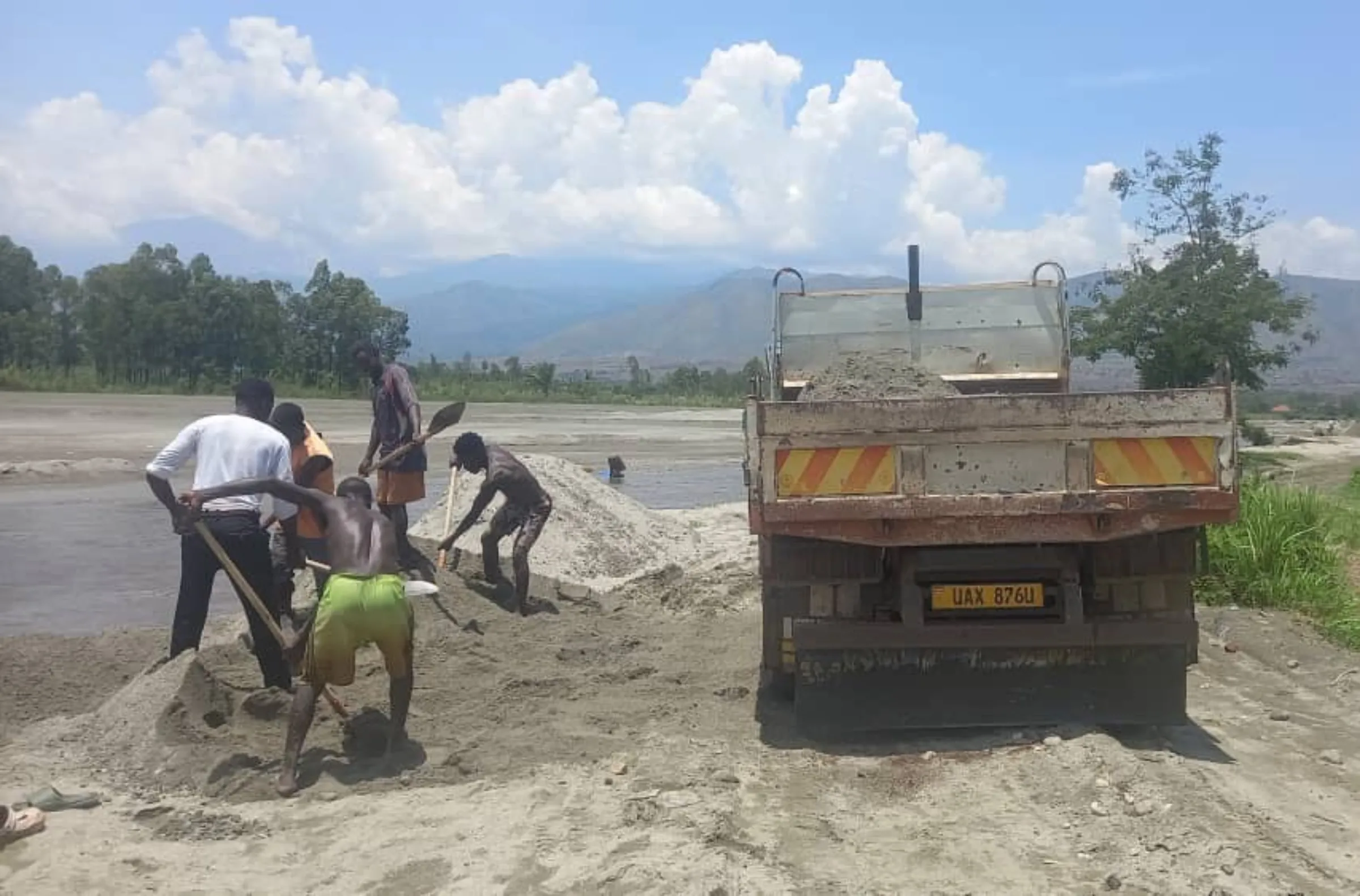 A digger mines sand along the Nyamwamba River