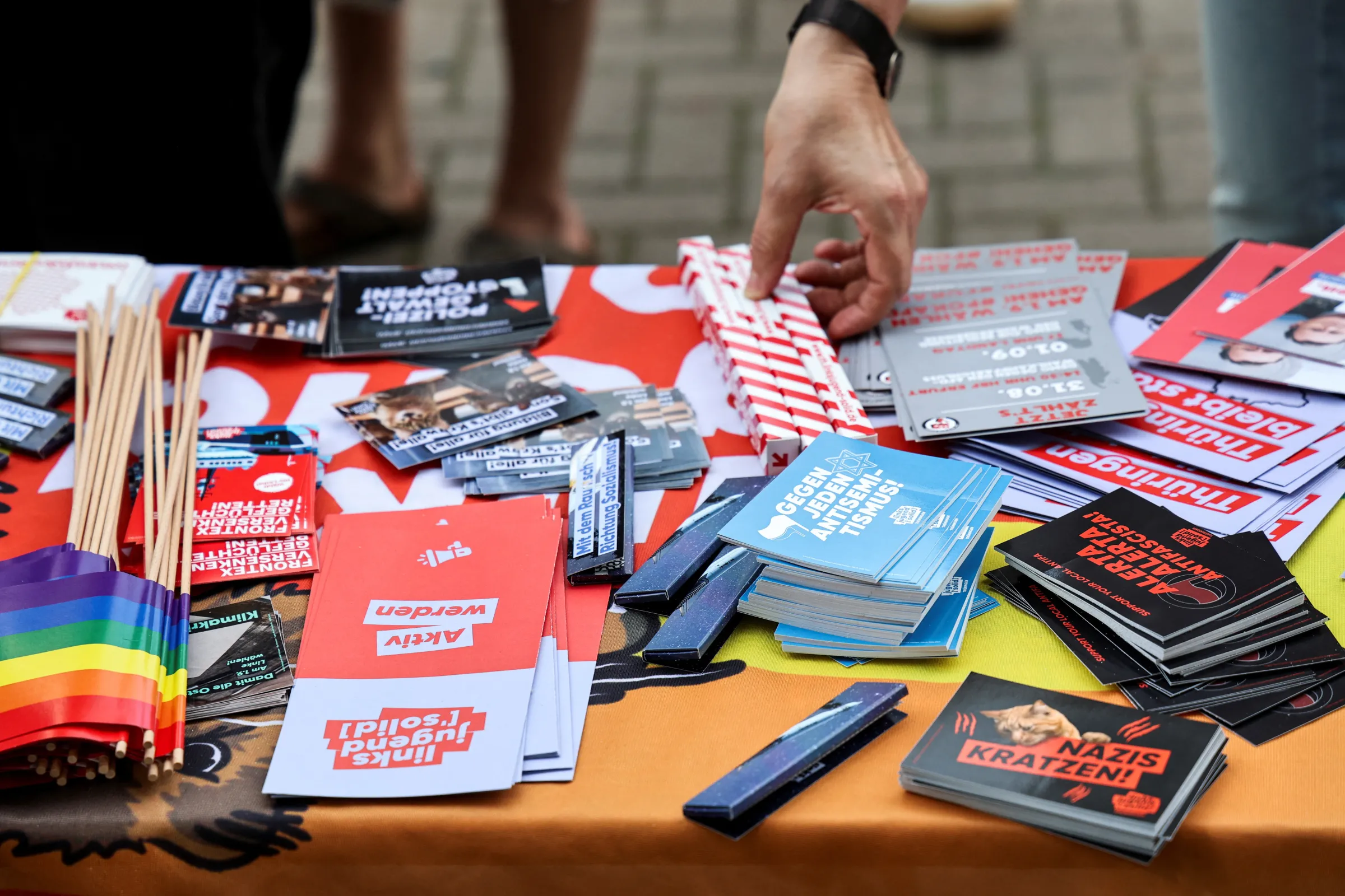 Flyers and other items are displayed on a table, as people attend the 'your voice against the right' protest against the Alternative for Germany (AfD), ahead of the state elections in Saxony and Thuringia, in Erfurt, Germany, August 25, 2024. REUTERS/Karina Hessland