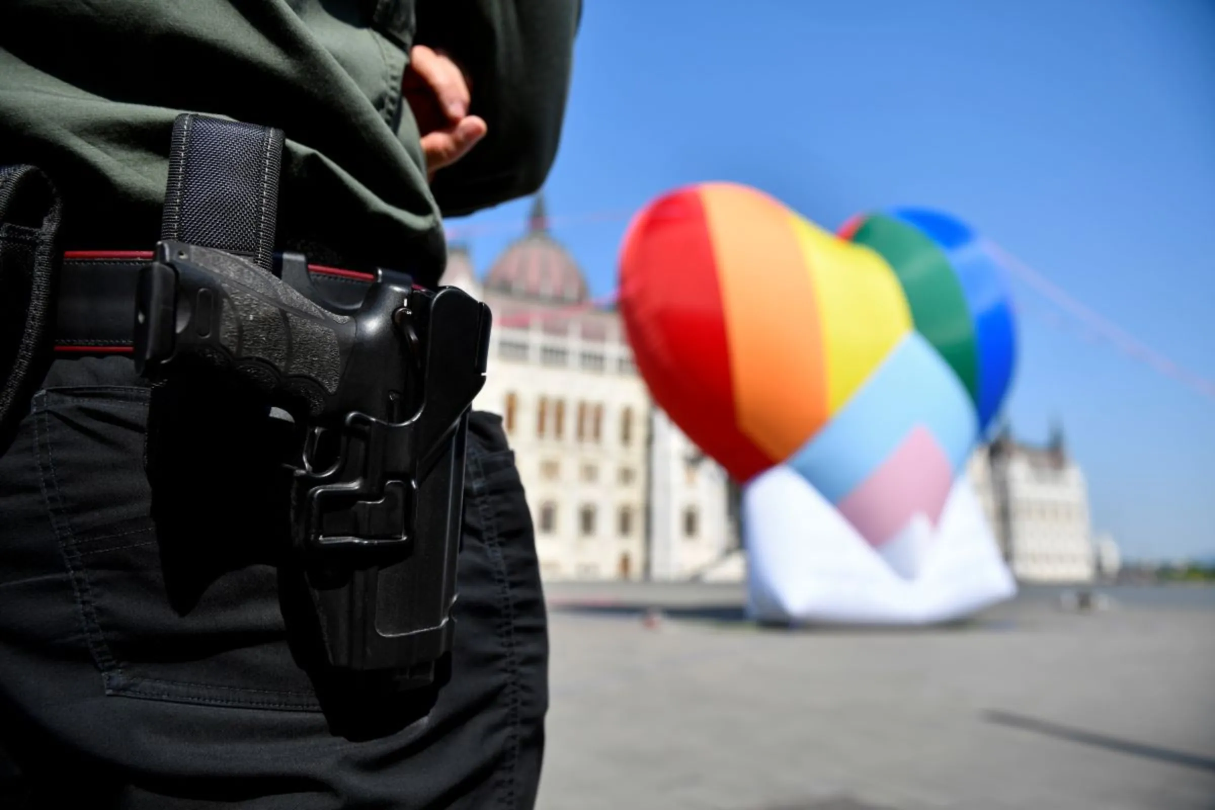 A security officer stands guard near a huge rainbow baloon at Hungary's parliament in protest against anti-LGBT law in Budapest, Hungary, July 8, 2021. REUTERS/Marton Monus