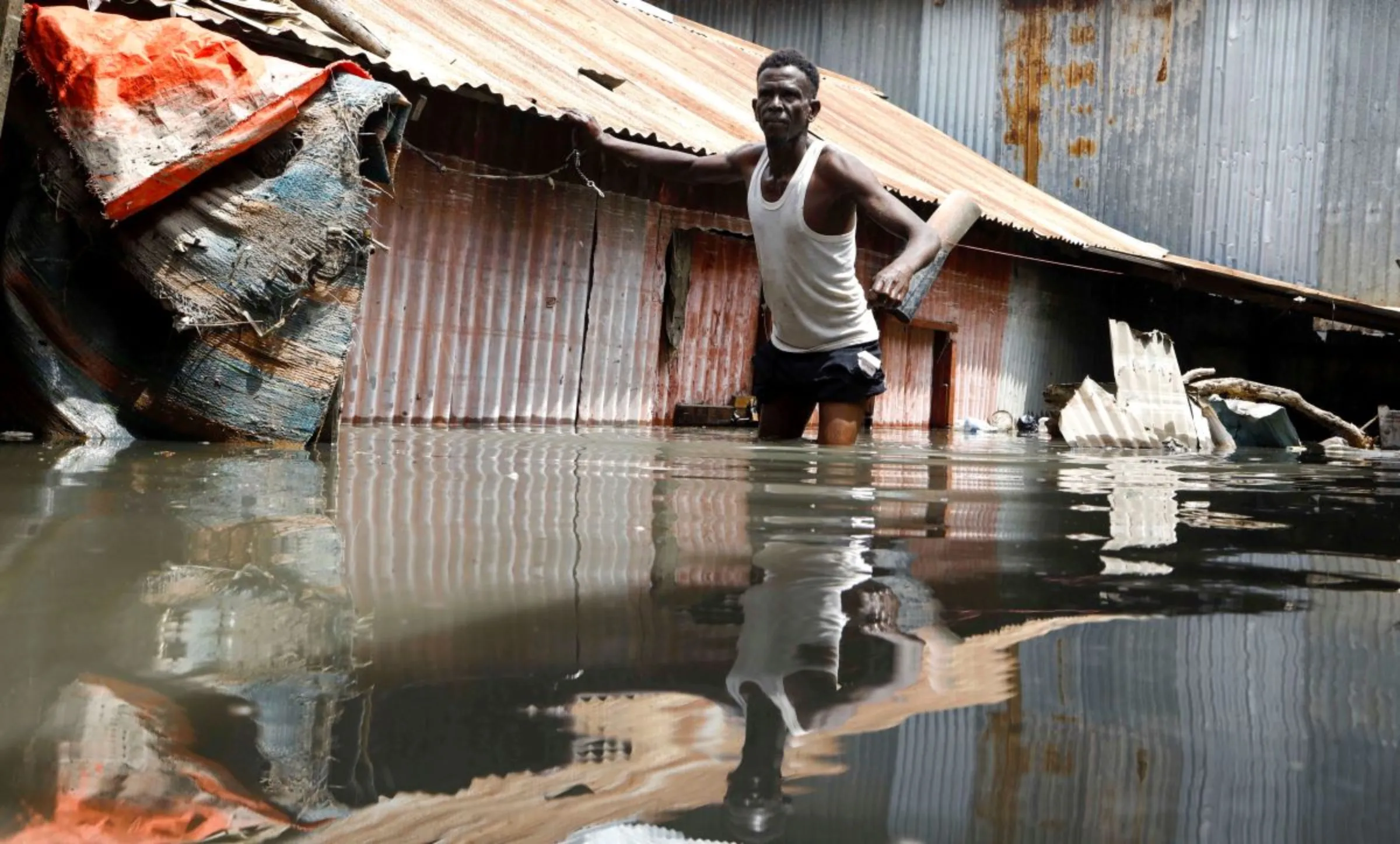 A man wades through flood waters following heavy rains in Mogadishu, Somalia November 9, 2023. REUTERS/Feisal Omar