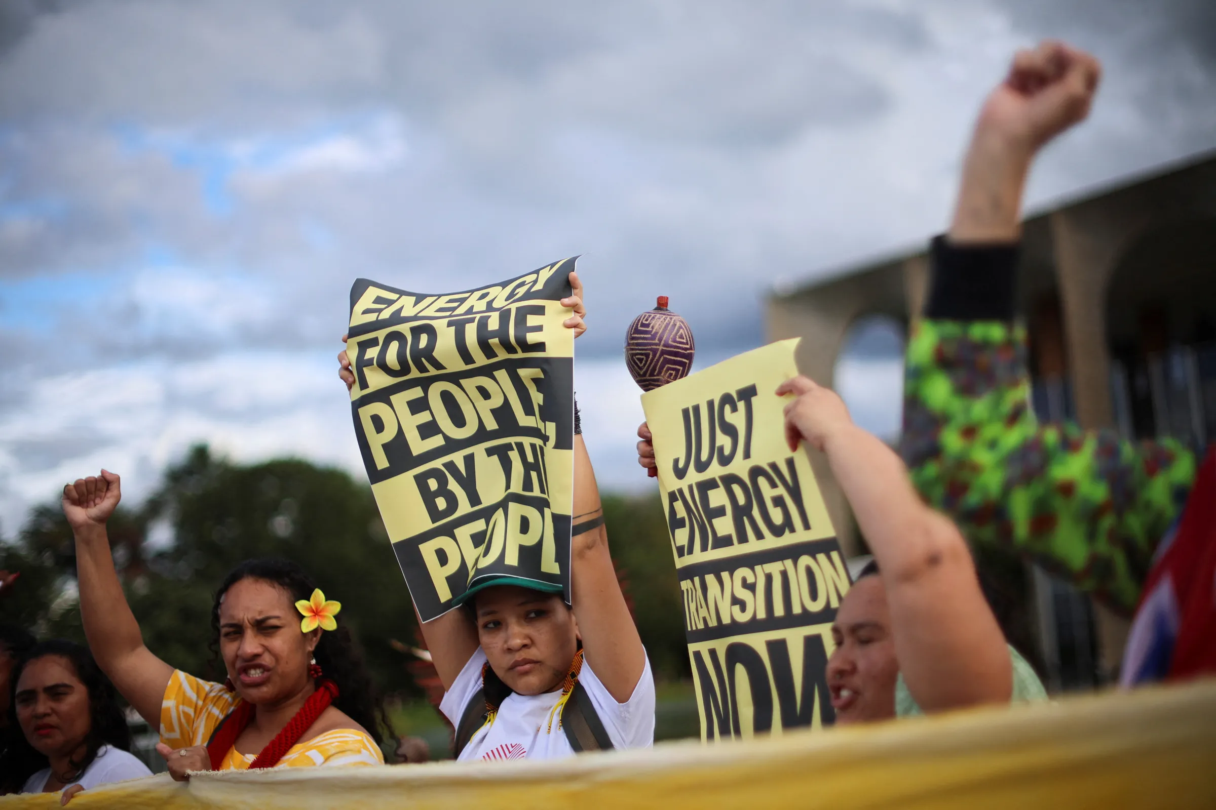 Activists hold signs during a performance and protest by Brazilian artist and activist Mundano, which asks for a response to the letter sent by the Terra Livre (Free Land) Indigenous movement to the presidency of COP30, in front of Itamaraty in Brasilia, Brazil April 15, 2025. REUTERS/Adriano Machado