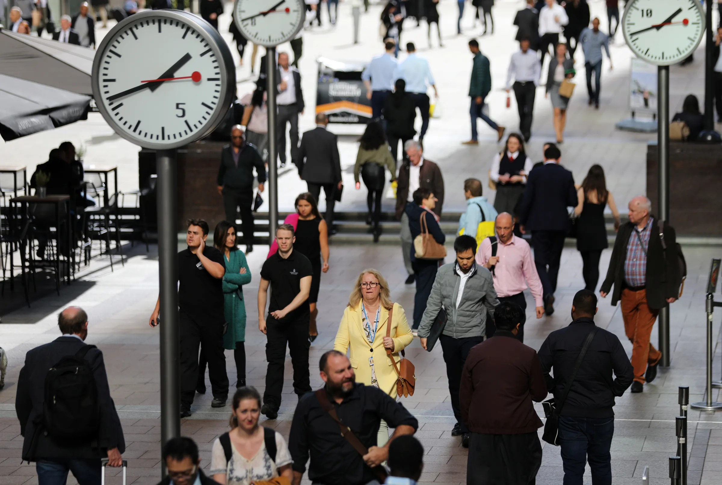 People walk through the financial district of Canary Wharf, London, Britain