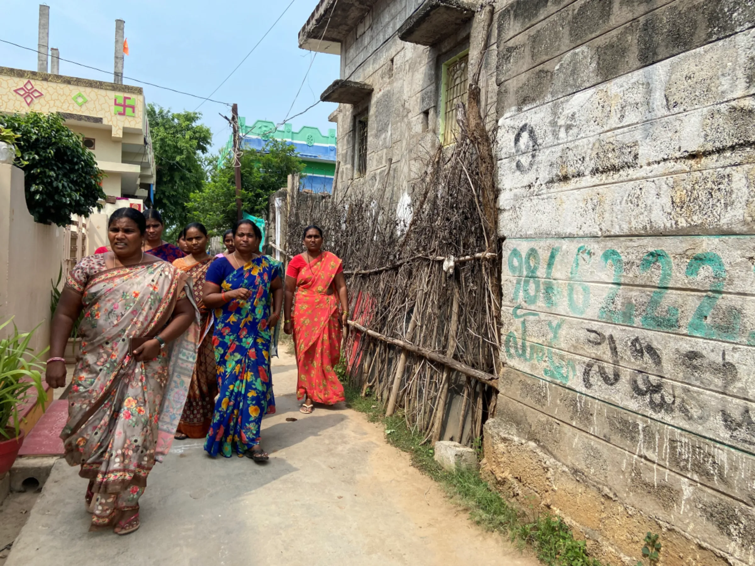 Members of a self-help group walk together in Chevaturu village, India, September 2, 2023