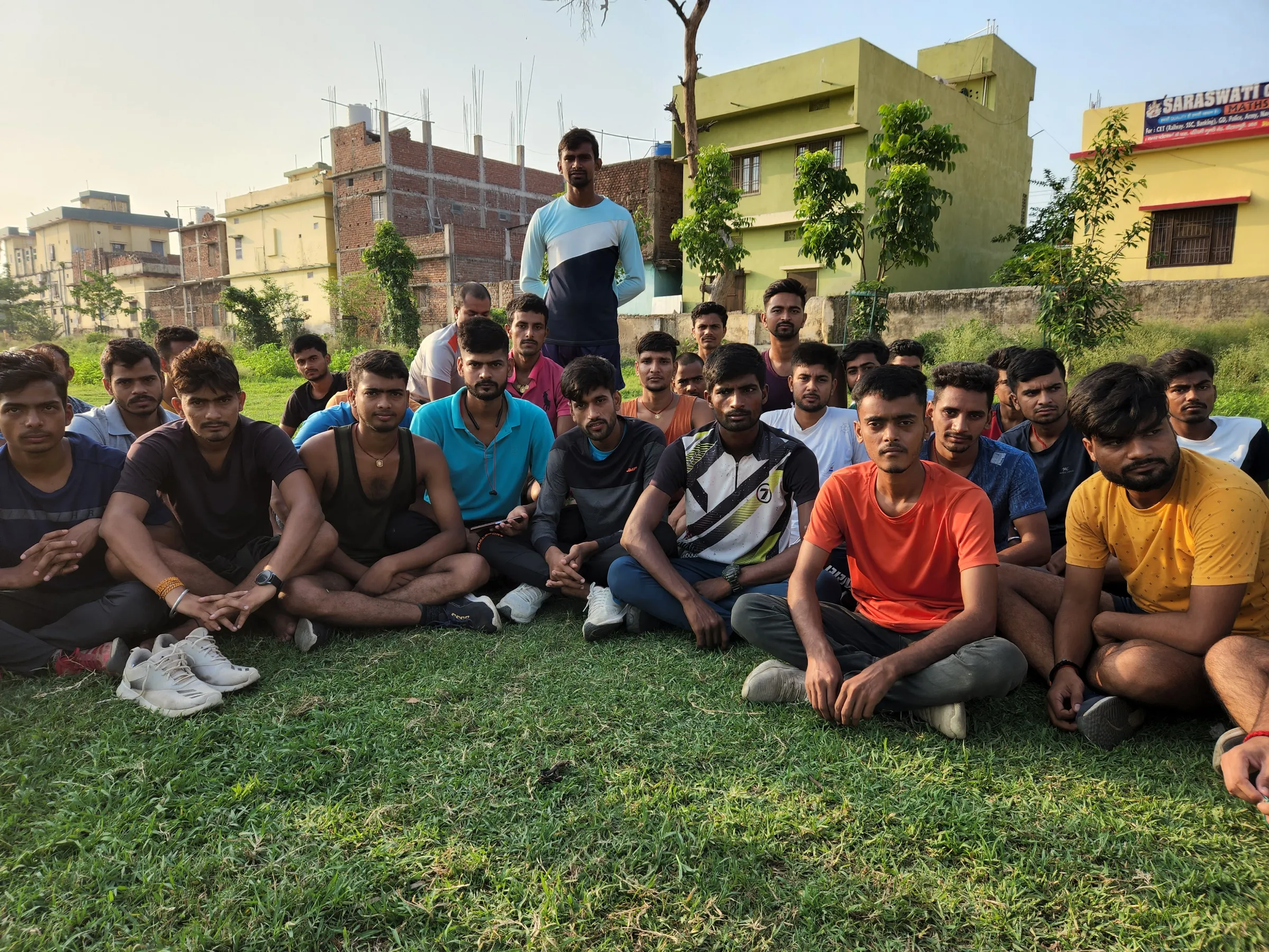 Young army aspirants pose for a photo together on grass