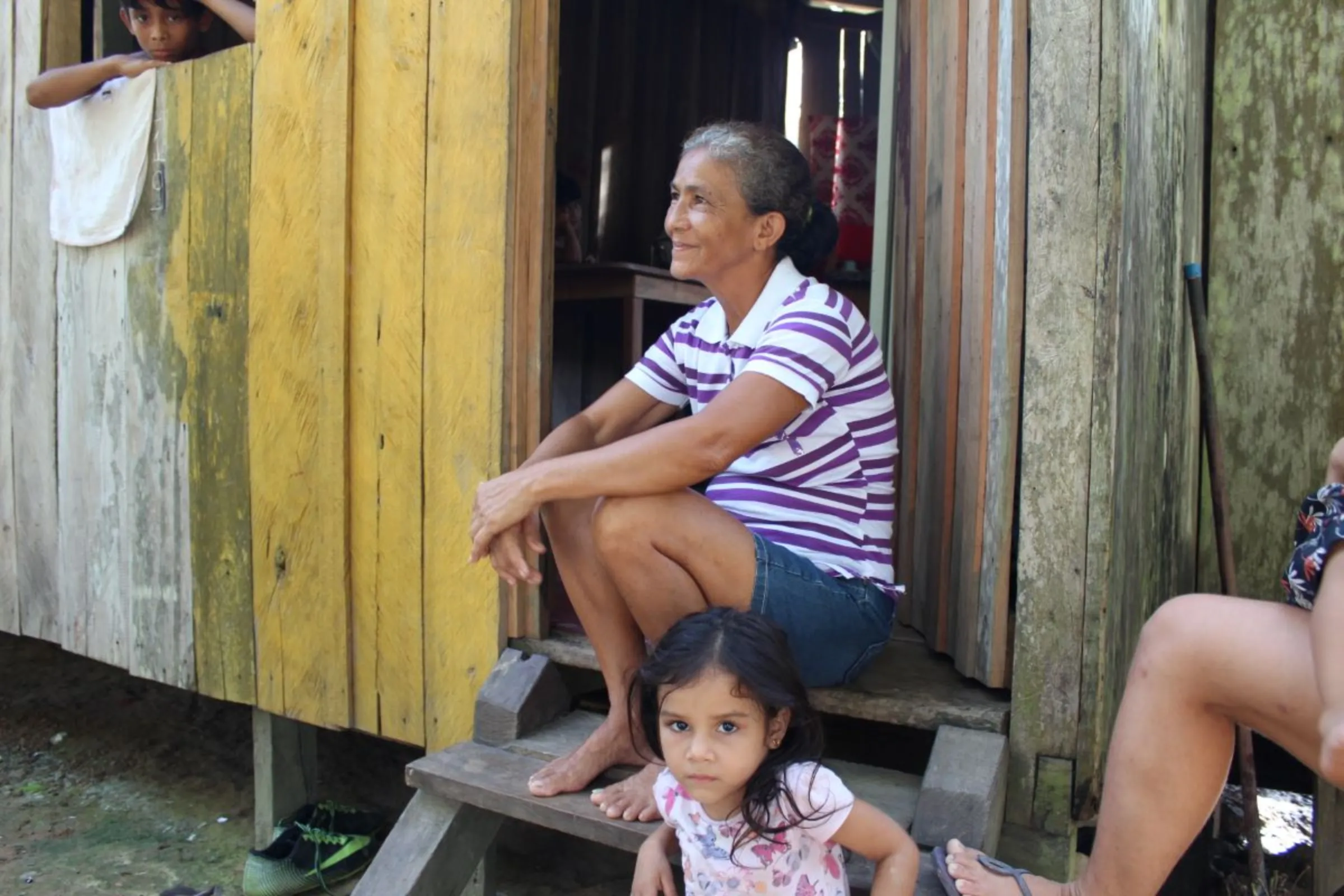 Açaí fruit collector Irzamar de Souza Mota sits in front of her house in Pirapitinga, near Humaitá, Brazil, Feb. 28, 2024. Thomson Reuters Foundation/André Cabette Fábio