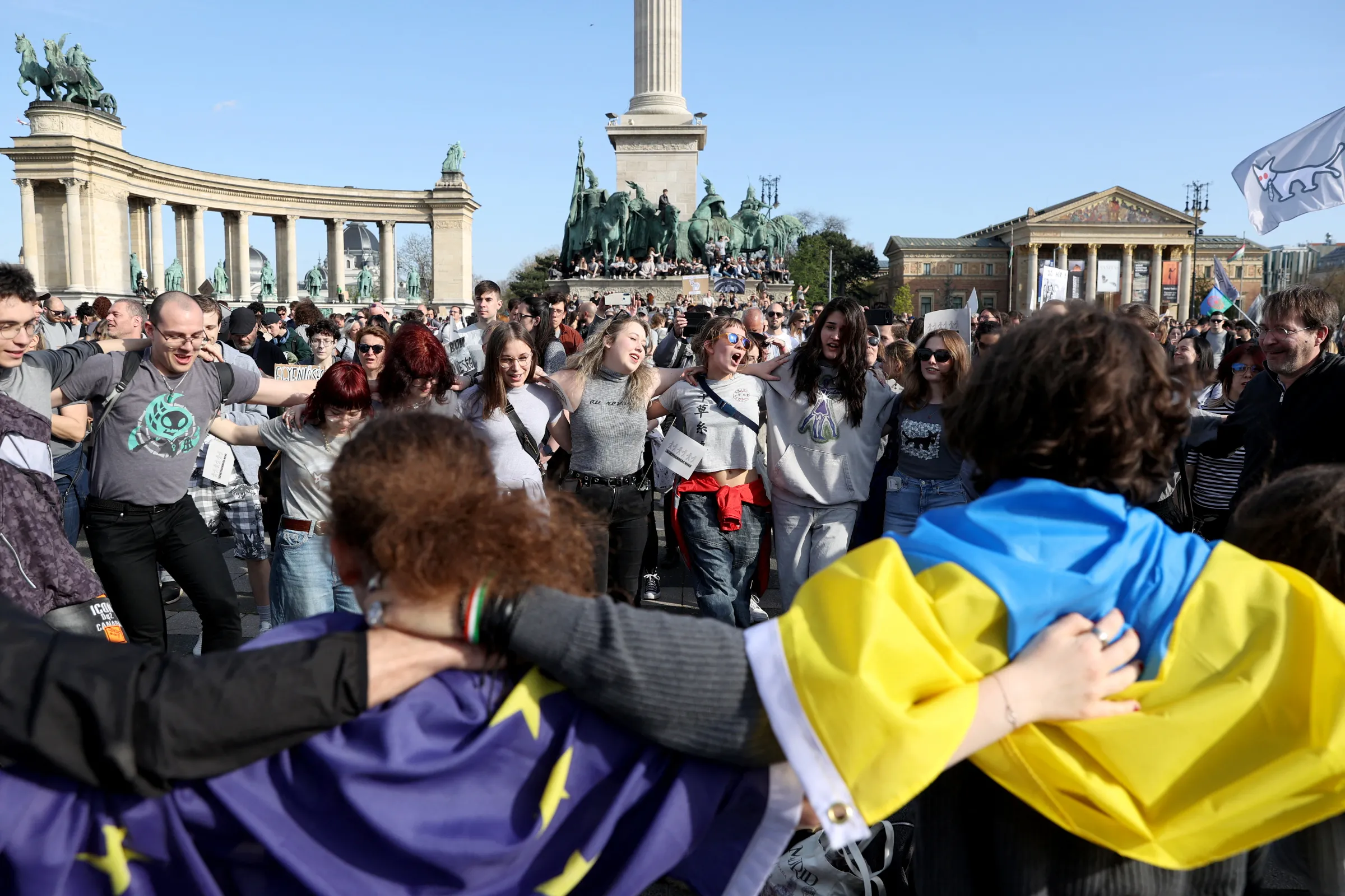 People dance as they gather at the Heroes' Square during the 'Let's all be the same' protest, called by The Two-Tailed Dog Party, against Hungarian Prime Minister Viktor Orban's moves to ban the annual Pride march in Budapest, Hungary, April 12, 2025. REUTERS/Bernadett Szabo