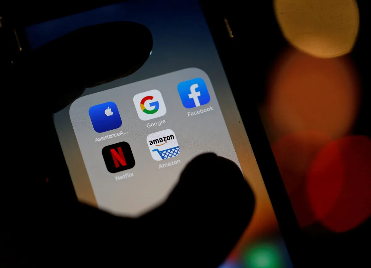 The logos of mobile apps, Google, Amazon, Facebook, Apple and Netflix, are displayed on a screen in this illustration picture taken December 3, 2019. REUTERS/Regis Duvignau/File Photo