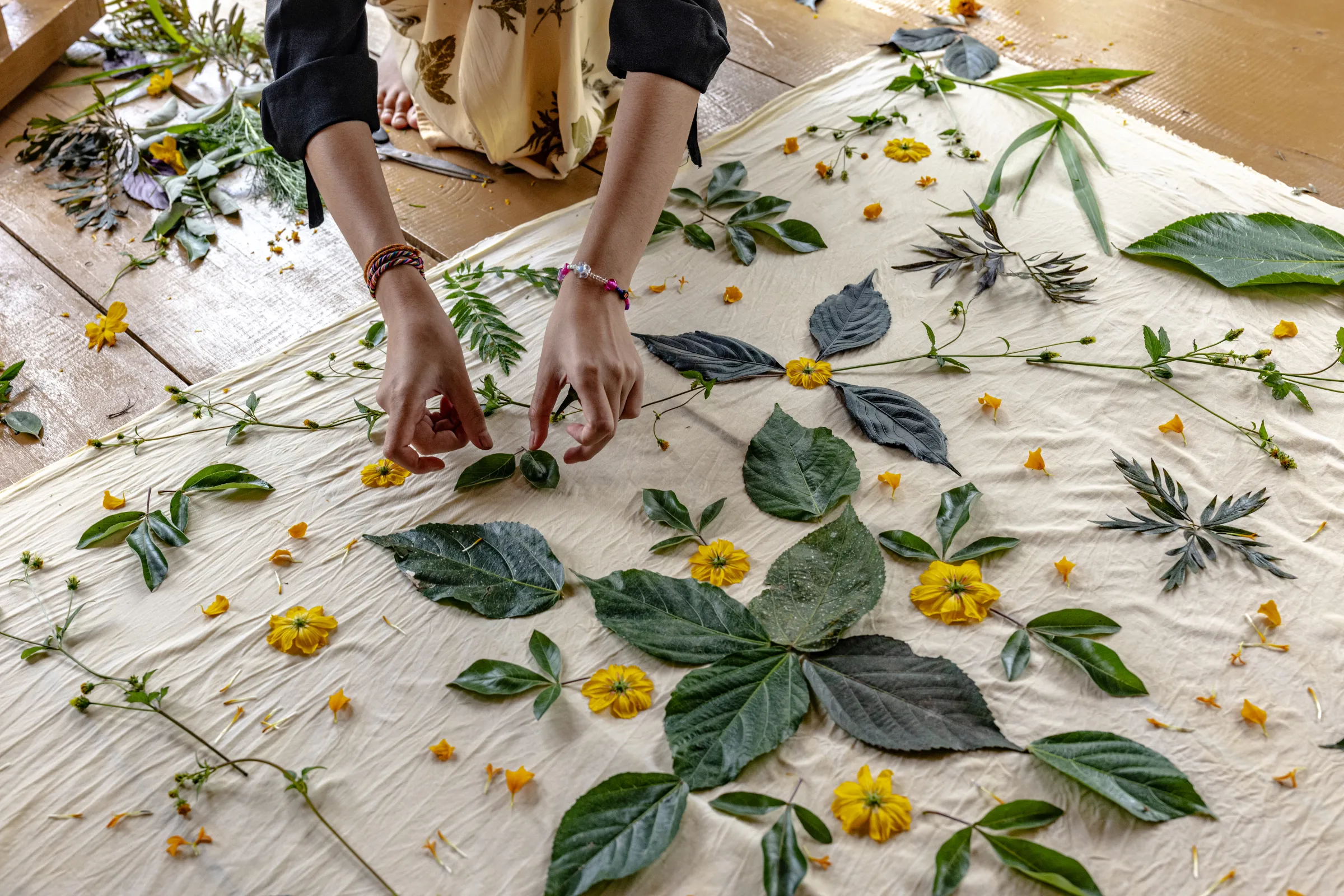 Members of the Ambu Halimun community arrange leaves and flowers according to the desired pattern during the ecoprinting process in Citalahab Central, West Java, Indonesia, on July 16, 2025. Thomson Reuters Foundation/Yudha Baskoro