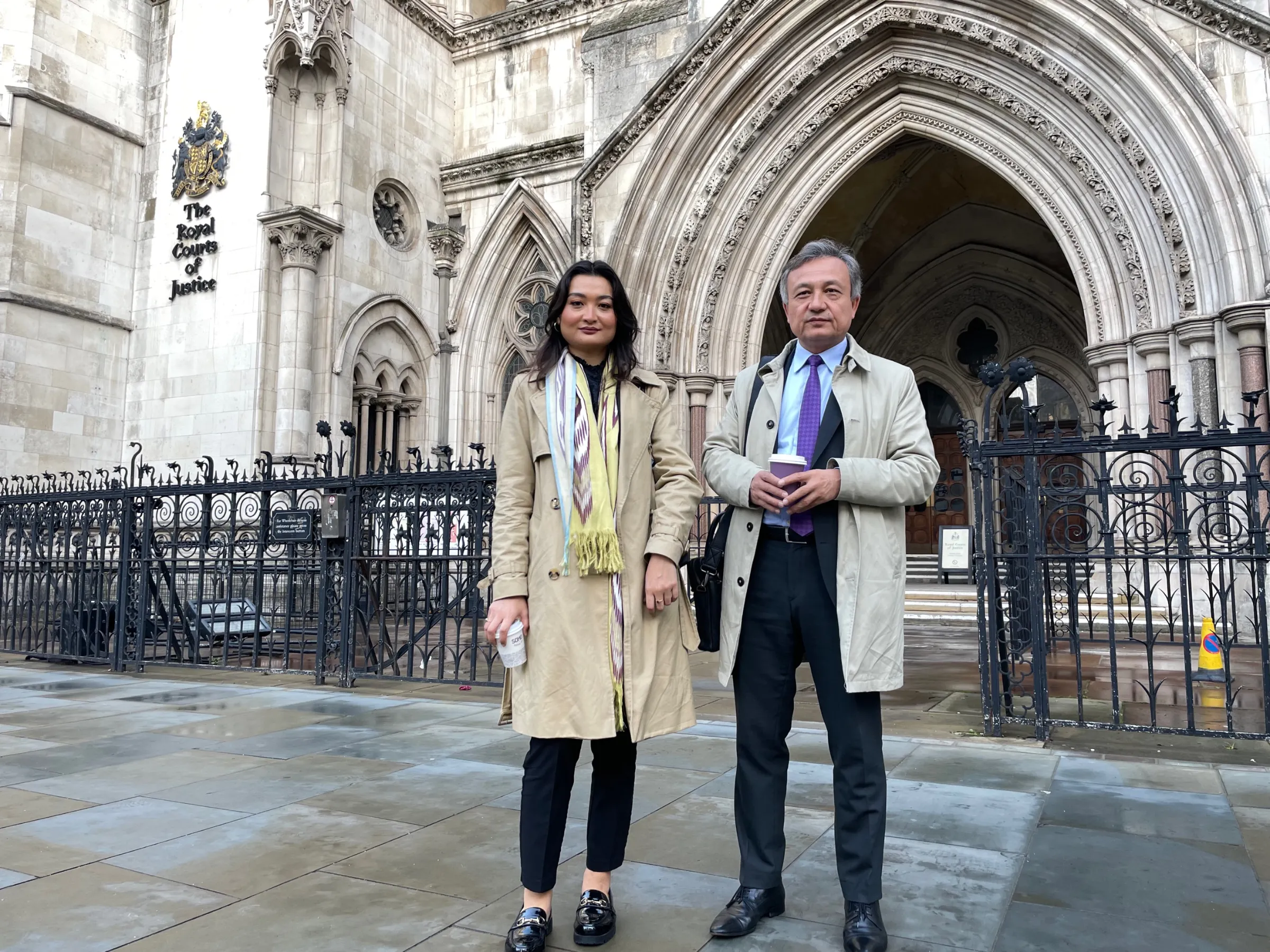 Uyghur activists Zumretay Arkin (L) and Dolkun Isa (R) from the World Uyghur Congress pose for a photo outside the High Court, Royal Courts of Justice on 25 October 2022, in London, Britain. THOMSON REUTERS FOUNDATION / Lin Taylor