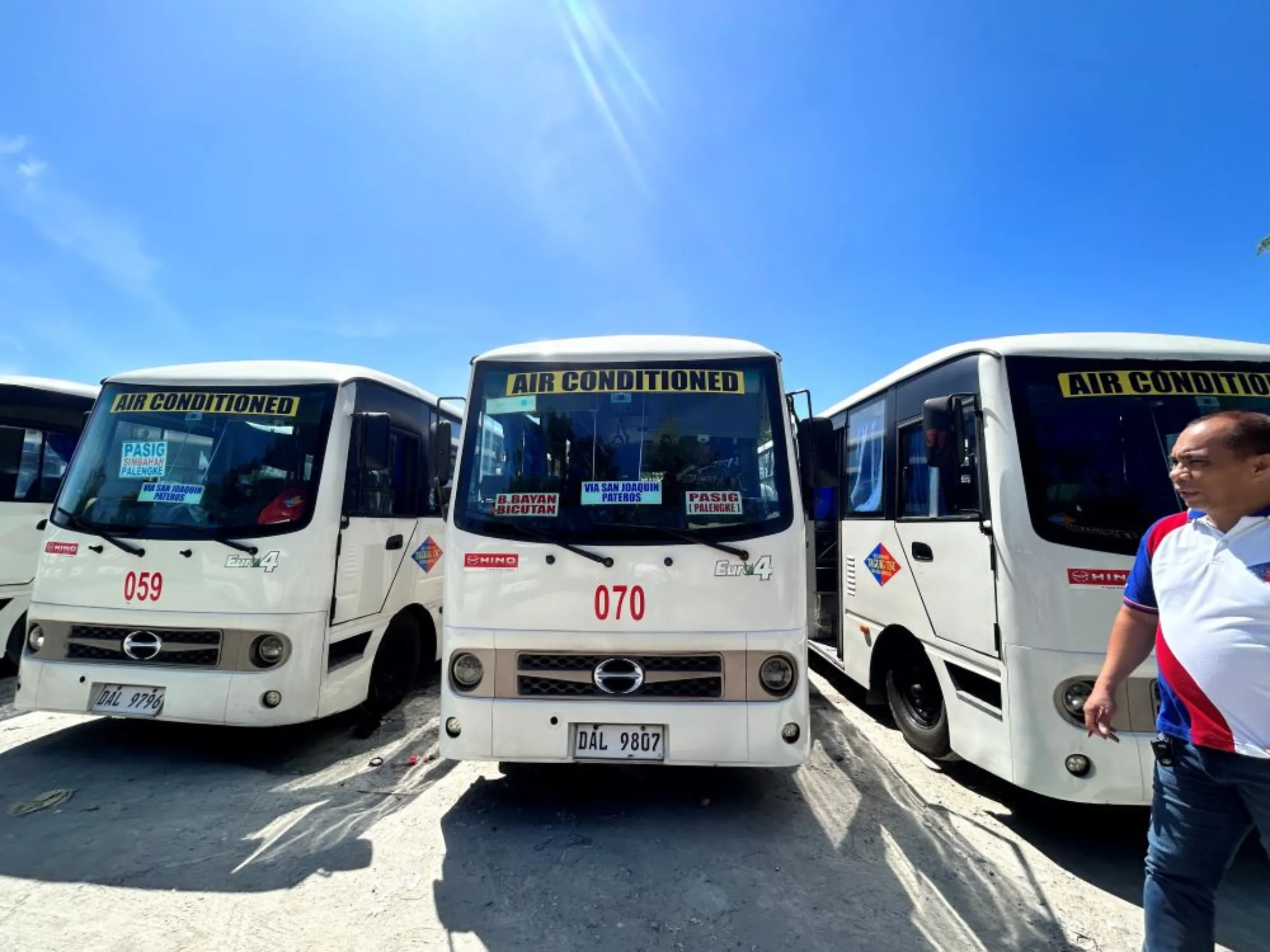 Freddie Hernandez, the head of a transport cooperative, poses with imported minibuses bought to replace traditional Jeepneys in Metro Manila, the Philippines, on February 17, 2023