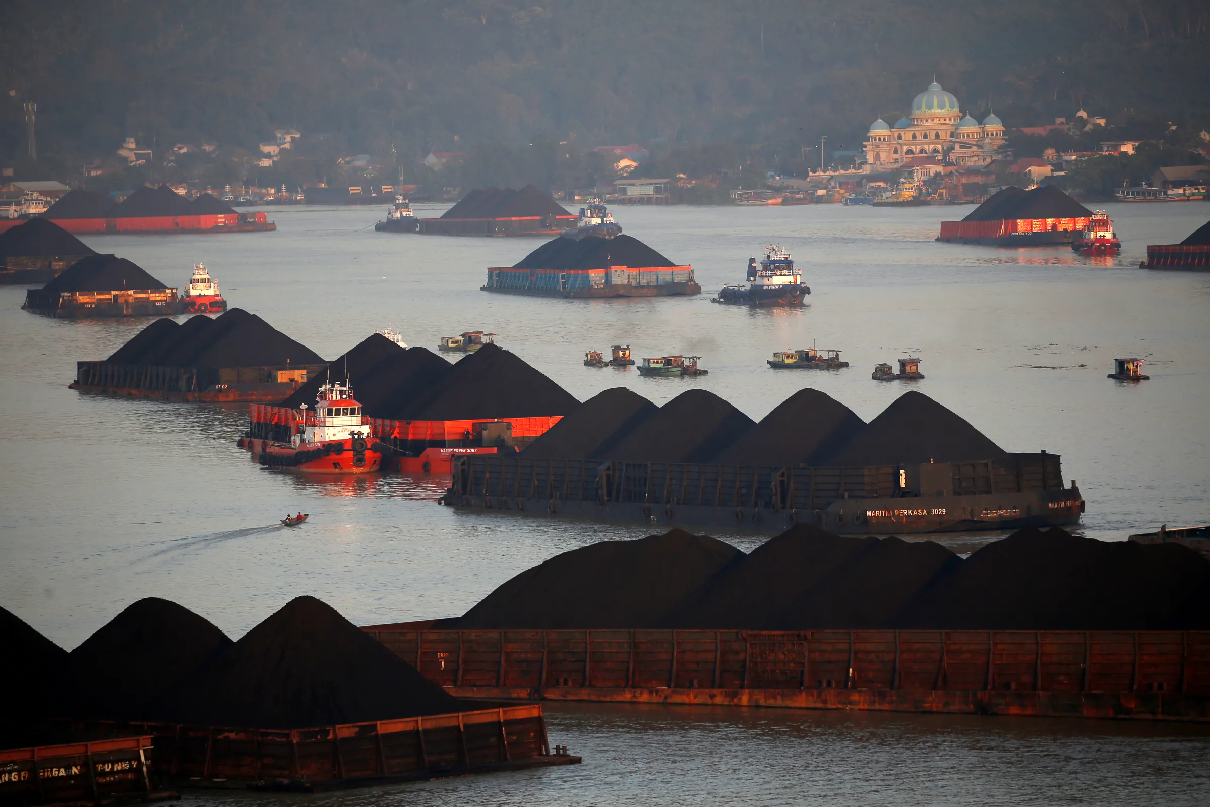 Coal barges are pictured as they queue to be pull along Mahakam river in Samarinda, East Kalimantan province, Indonesia, August 31, 2019