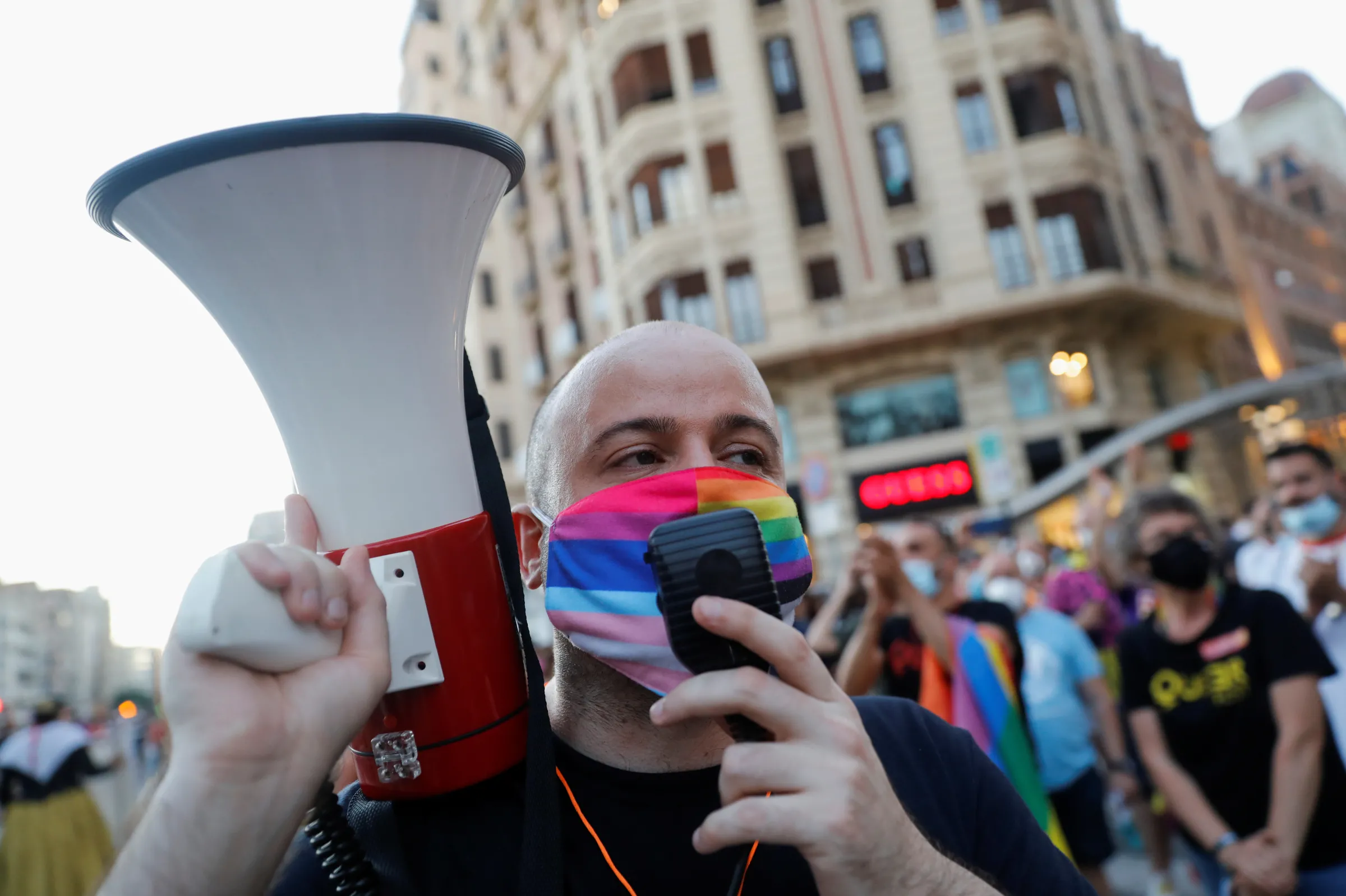 A demonstrator uses a megaphone during a protest on LGBT Pride Day in Valencia, Spain, June 28, 2021. REUTERS/Eva Manez