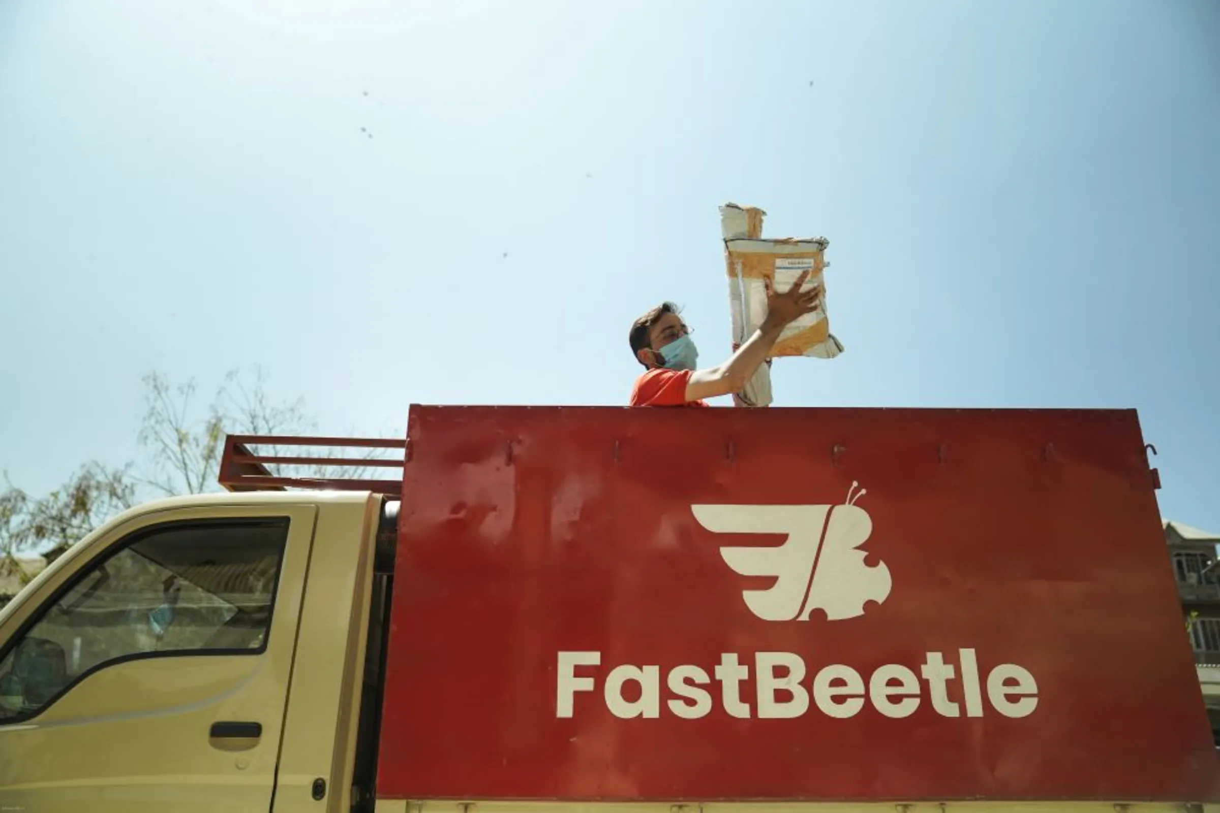 A delivery boy of FastBeetle, the first local courier service in Kashmir, handles packages in Srinagar, India. FastBeetle/Handout via Thomson Reuters Foundation