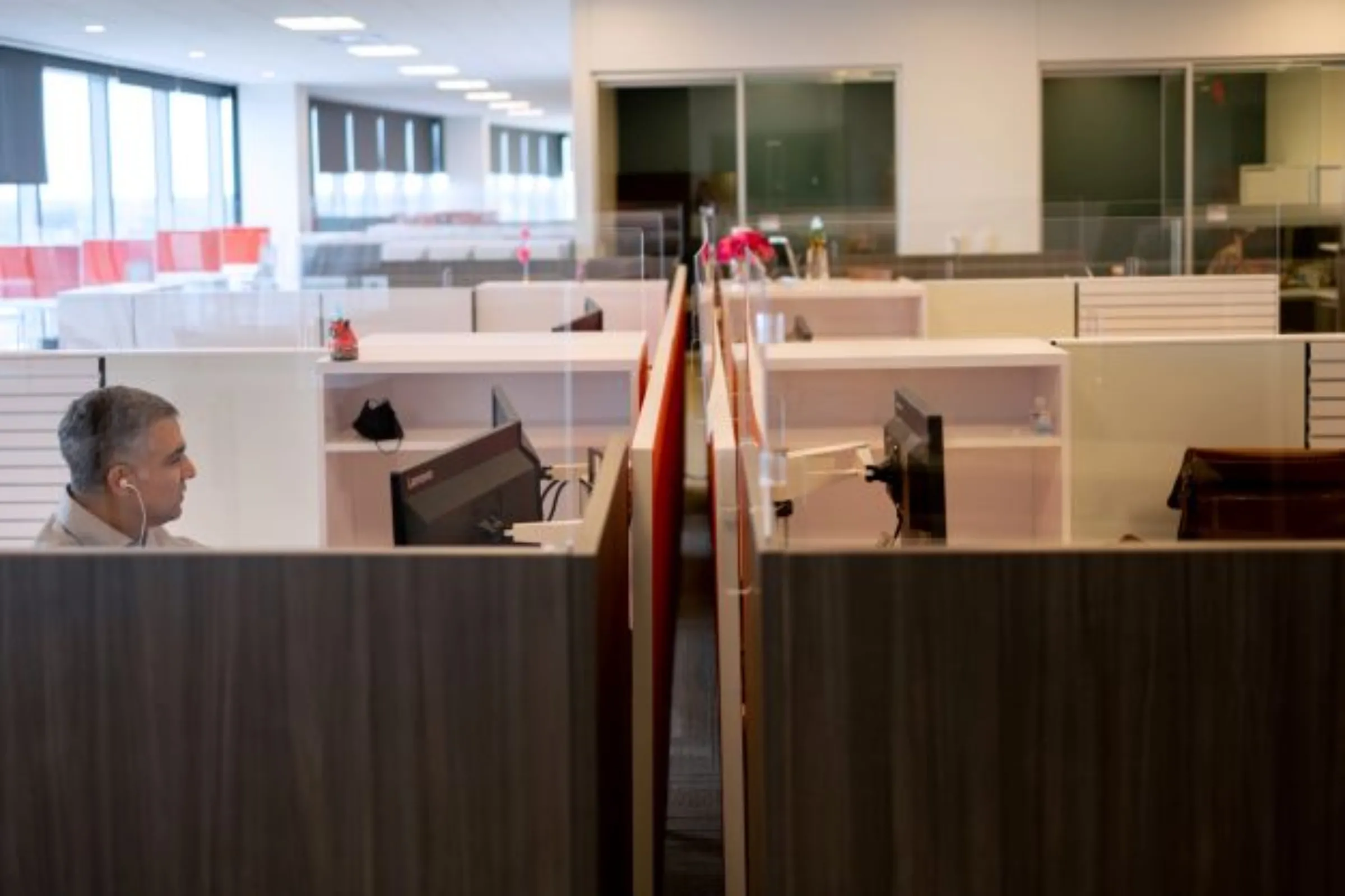 A man works on his computer as the first phase of FMC Corporation employees return to work in the office in Philadelphia, Pennsylvania, U.S., June 14, 2021. REUTERS/Hannah Beier