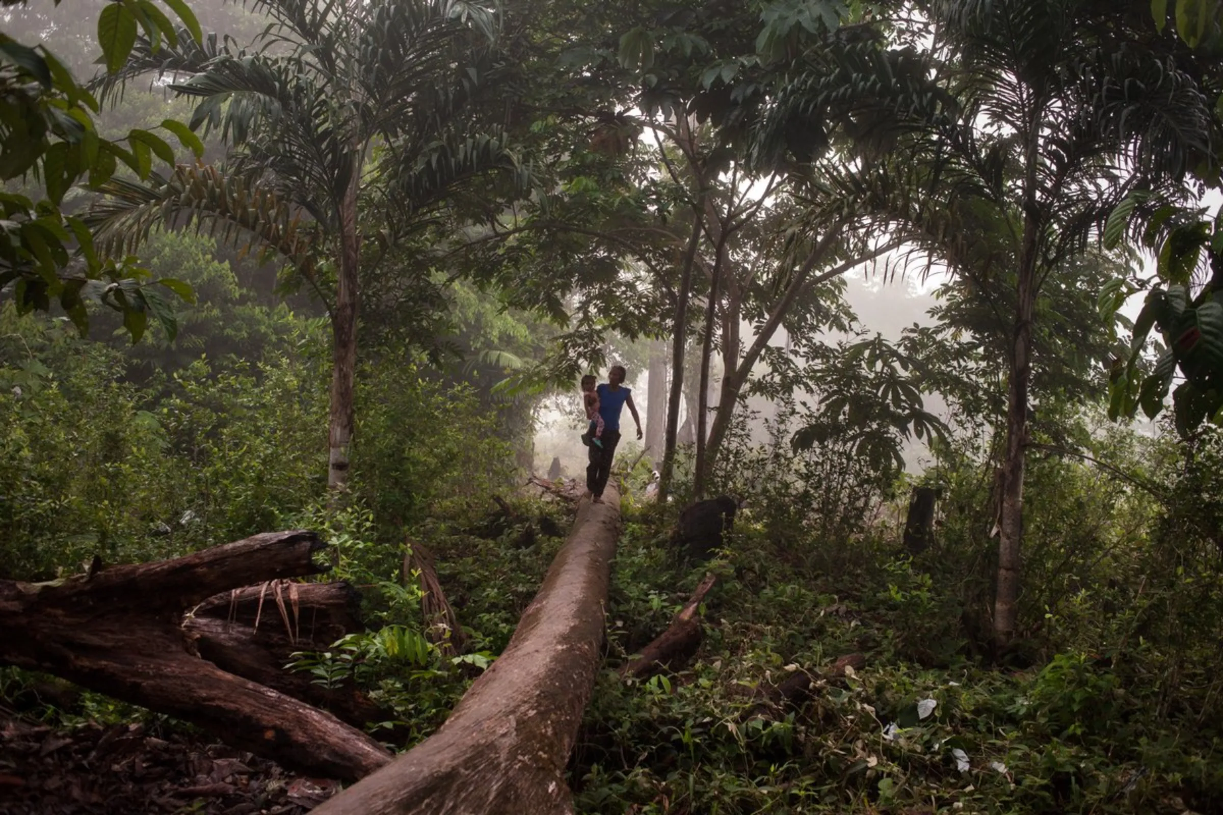 An indigenous woman and her child walk in near-pristine Amazon rainforest in Colombia’s southeast Amazonas province, Miriti- Parana, Colombia, December 20, 2021