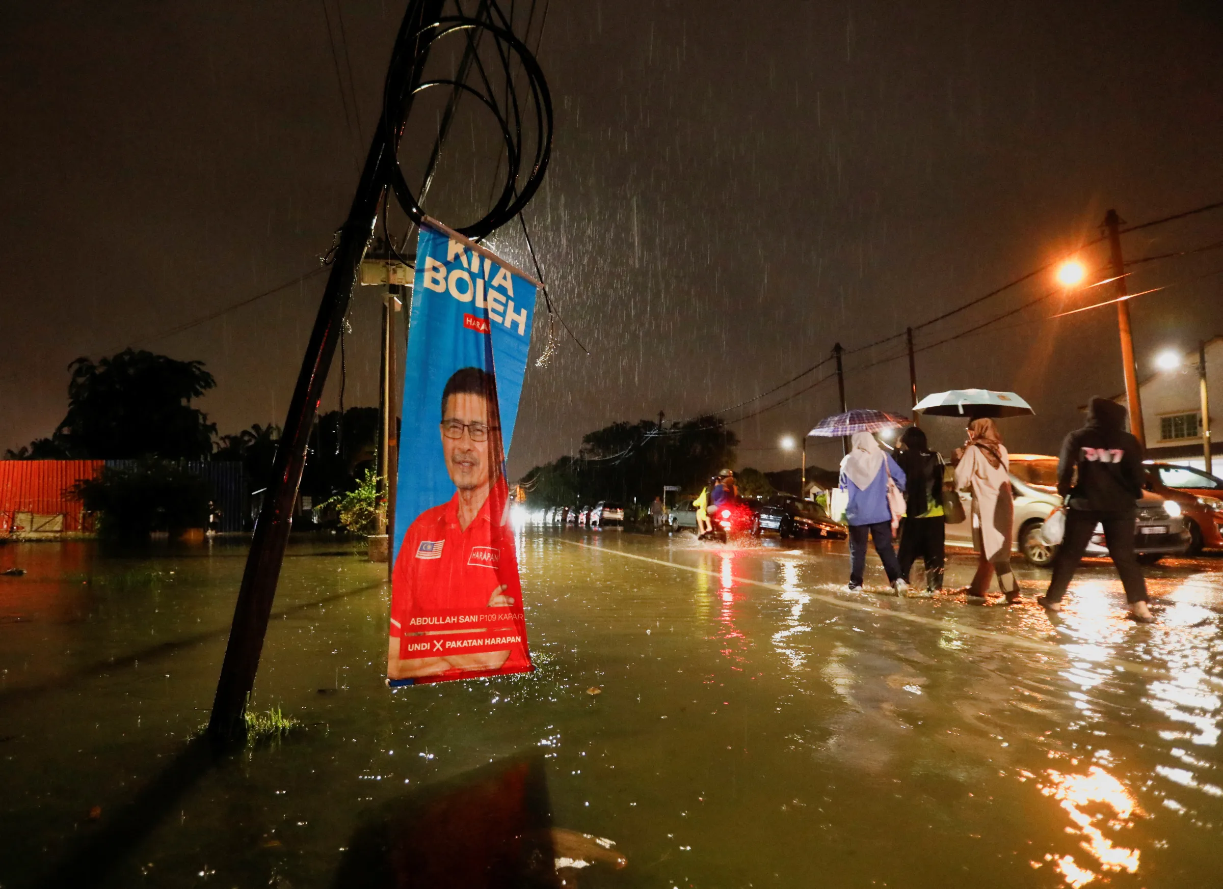 An election banner is surrounded by the flood water during a flash flood at Klang, Selangor, Malaysia November 10, 2022. REUTERS/Hasnoor Hussain