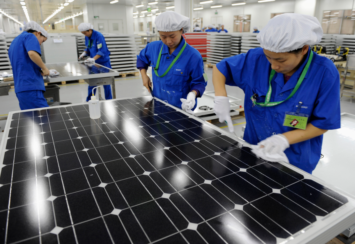 Employees inspect solar panels at a workshop in Chint Solar Co. Ltd. factory in Hangzhou, Zhejiang province December 8, 2009. REUTERS/Lang Lang