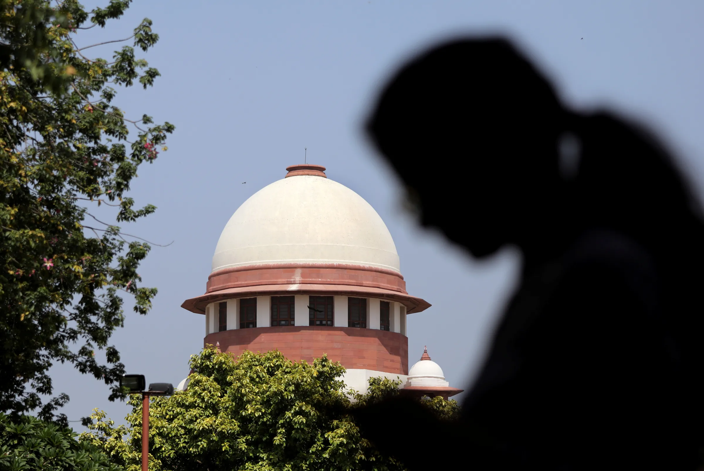 A woman checks her mobile phone inside the premises of the Supreme Court in New Delhi, India, September 28, 2018