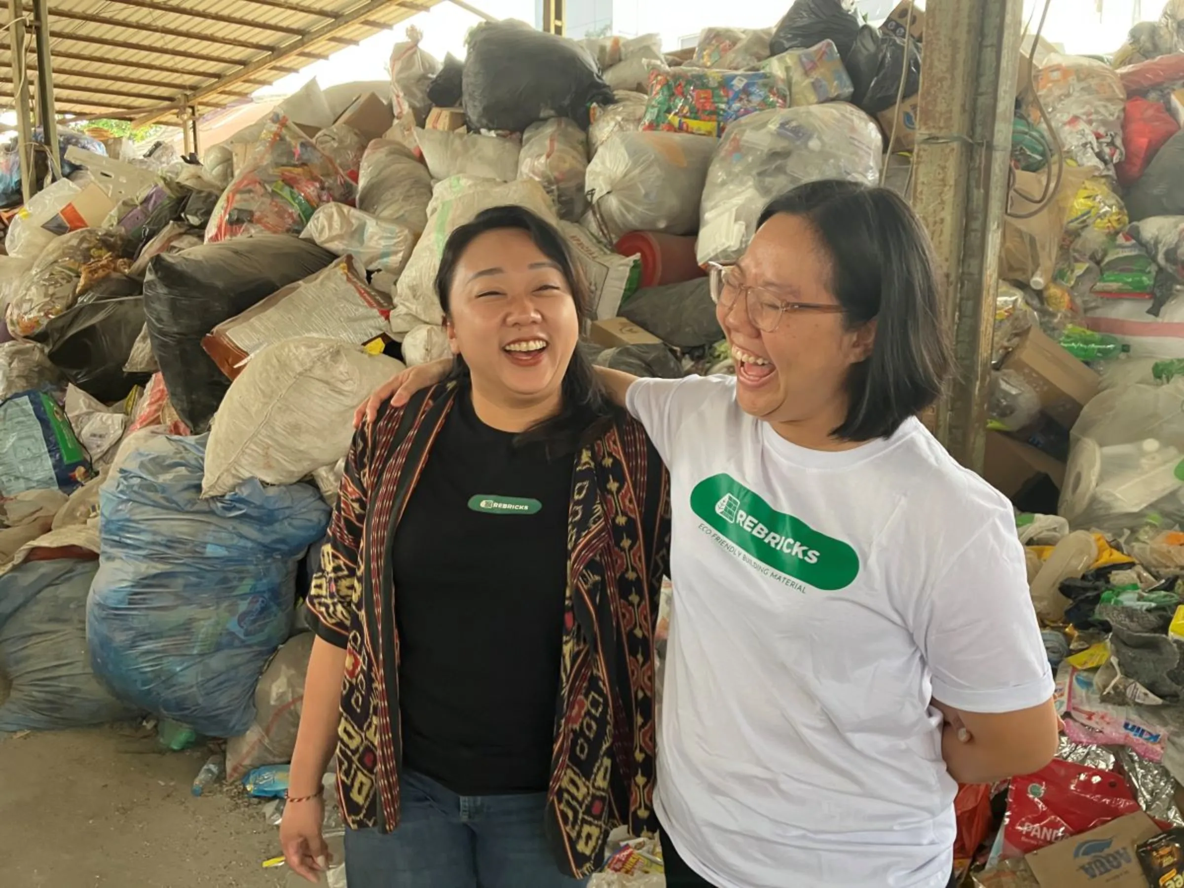 Rebricks founders Ovy Sabrina and Novita Tan at their building materials yard in Jakarta on August 12, 2023. Thomson Reuters Foundation/Michael Taylor