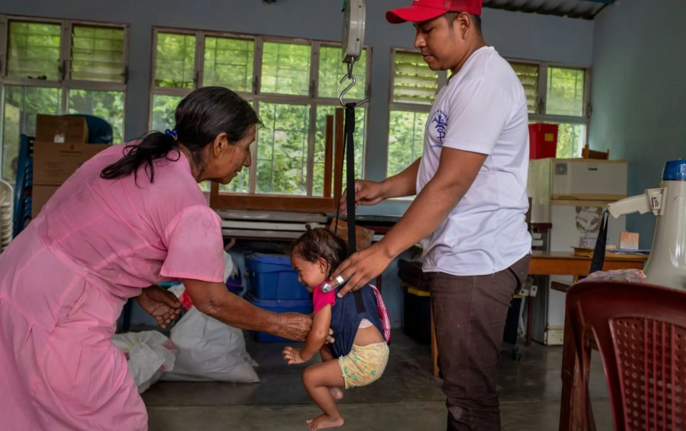 A malnourished child and her grandmother attend a medical check-up in a remote rural clinic in the Camotán municipality in the province of Chiquimula, Guatemala, September 8, 2023. Thomson Reuters Foundation/Fabio Cuttica