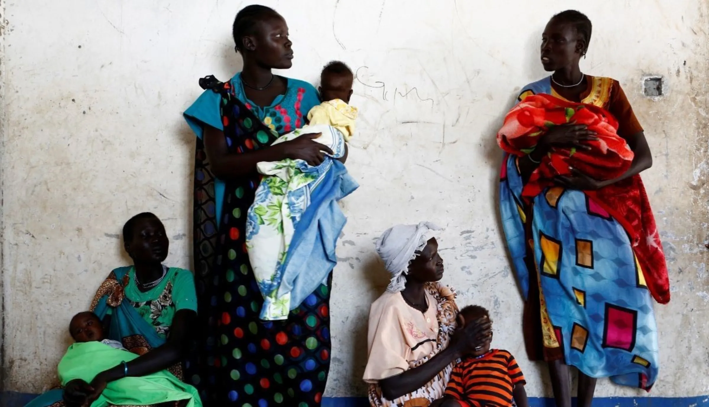 Women hold their babies as they wait for a medical check-up at a United Nations International Children's Fund (UNICEF) supported mobile health clinic in Nimini village, Unity State, South Sudan February 8, 2017