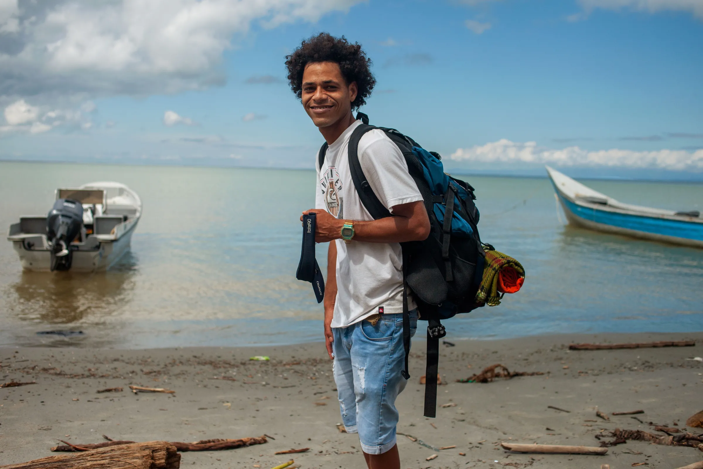 Douglas, a 31-year-old Venezuelan migrant traveling alone, poses for a photo on the beach in the Colombian town of Necocli before boarding a boat to Capurgana from where the jungle trek across the Darién Gap begins. Necocli, Colombia, July 29, 2022. Thomson Reuters Foundation/Fabio Cuttica
