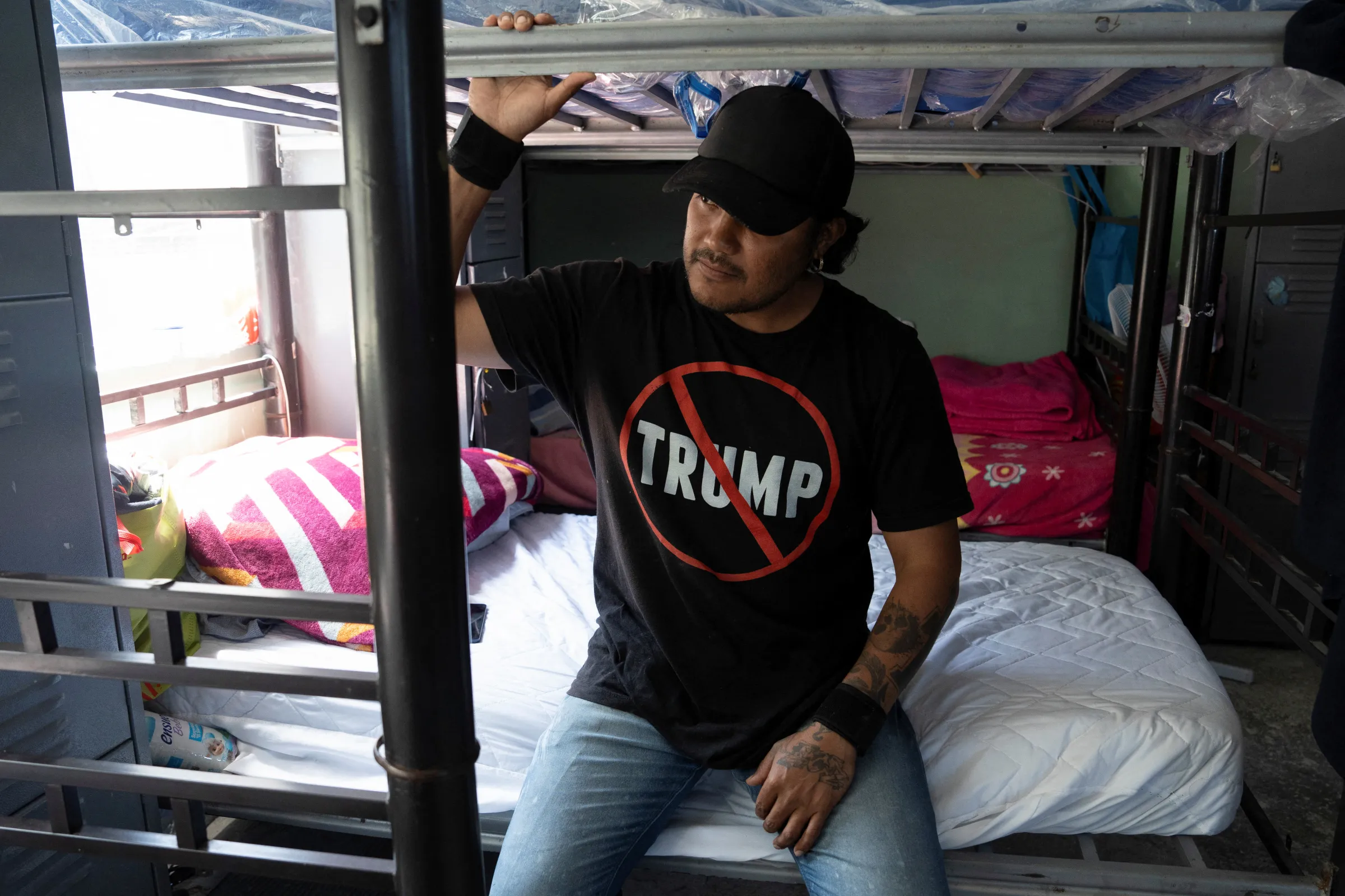 A Mexican migrant, recently deported after being apprehended in a U.S. Immigration and Customs Enforcement (ICE) raid, sits in a bed at an LGBTQ+ shelter in Tijuana, Mexico, July 30, 2025. REUTERS/Aimee Melo