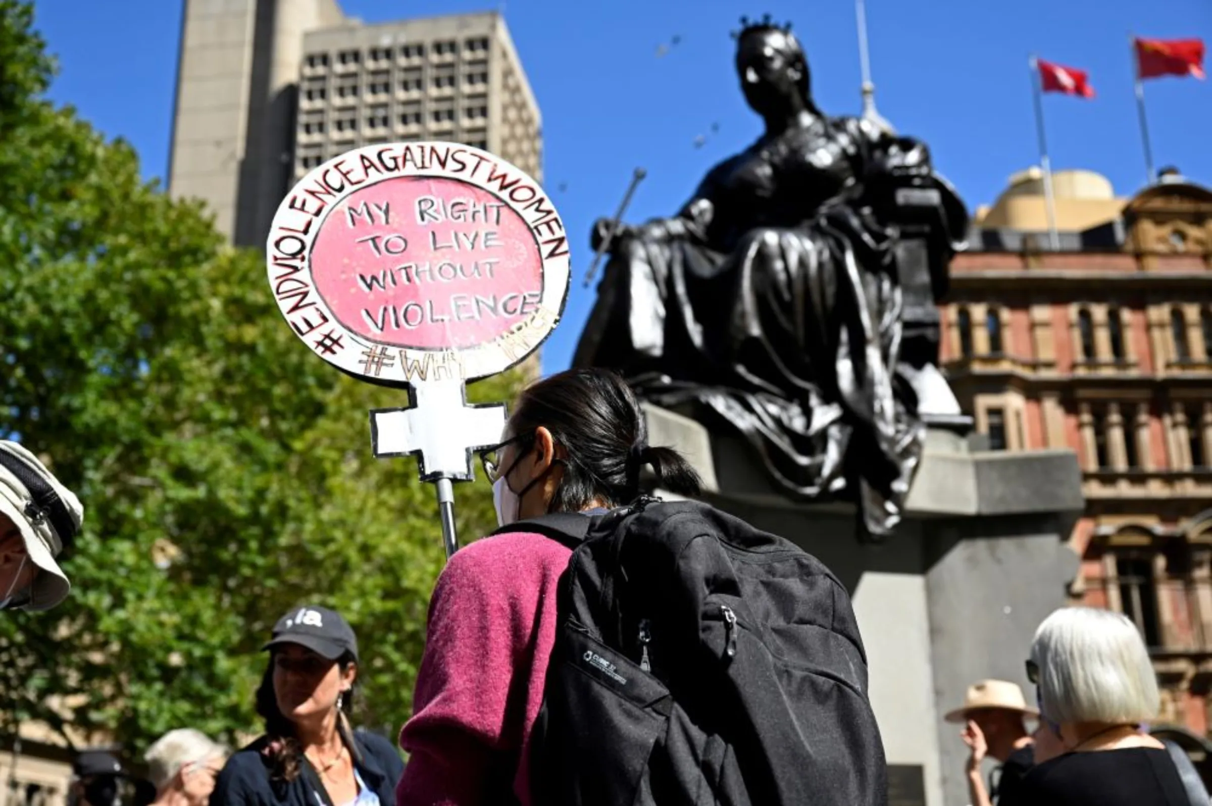 A protester holds a sign addressing violence against women in response to the treatment of women in politics following several sexual assault allegations, as part of the Women's March 4 Justice rally in Sydney, Australia, March 15, 2021