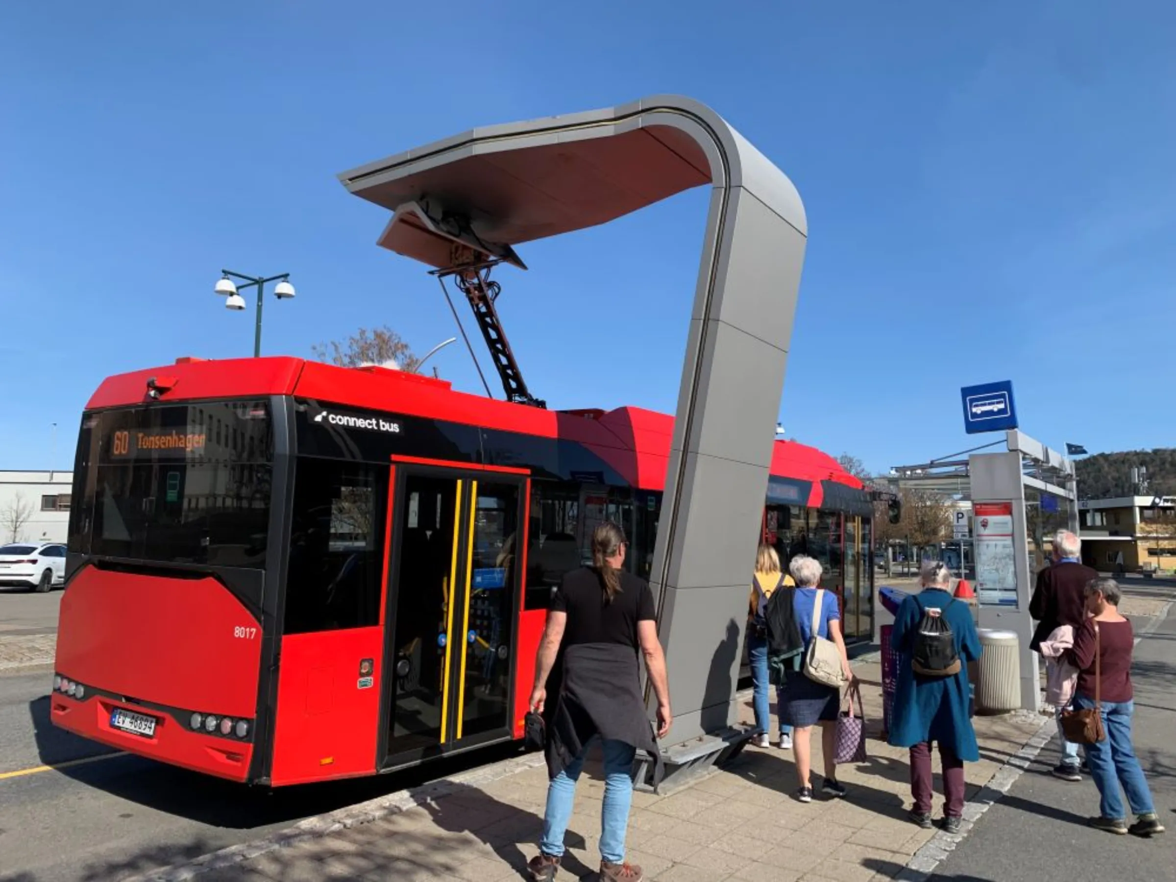 An electric bus connects to a rooftop charging point in Oslo, April 18, 2023. Oslo says it will become, this year, the world’s first capital city with only electric public transport