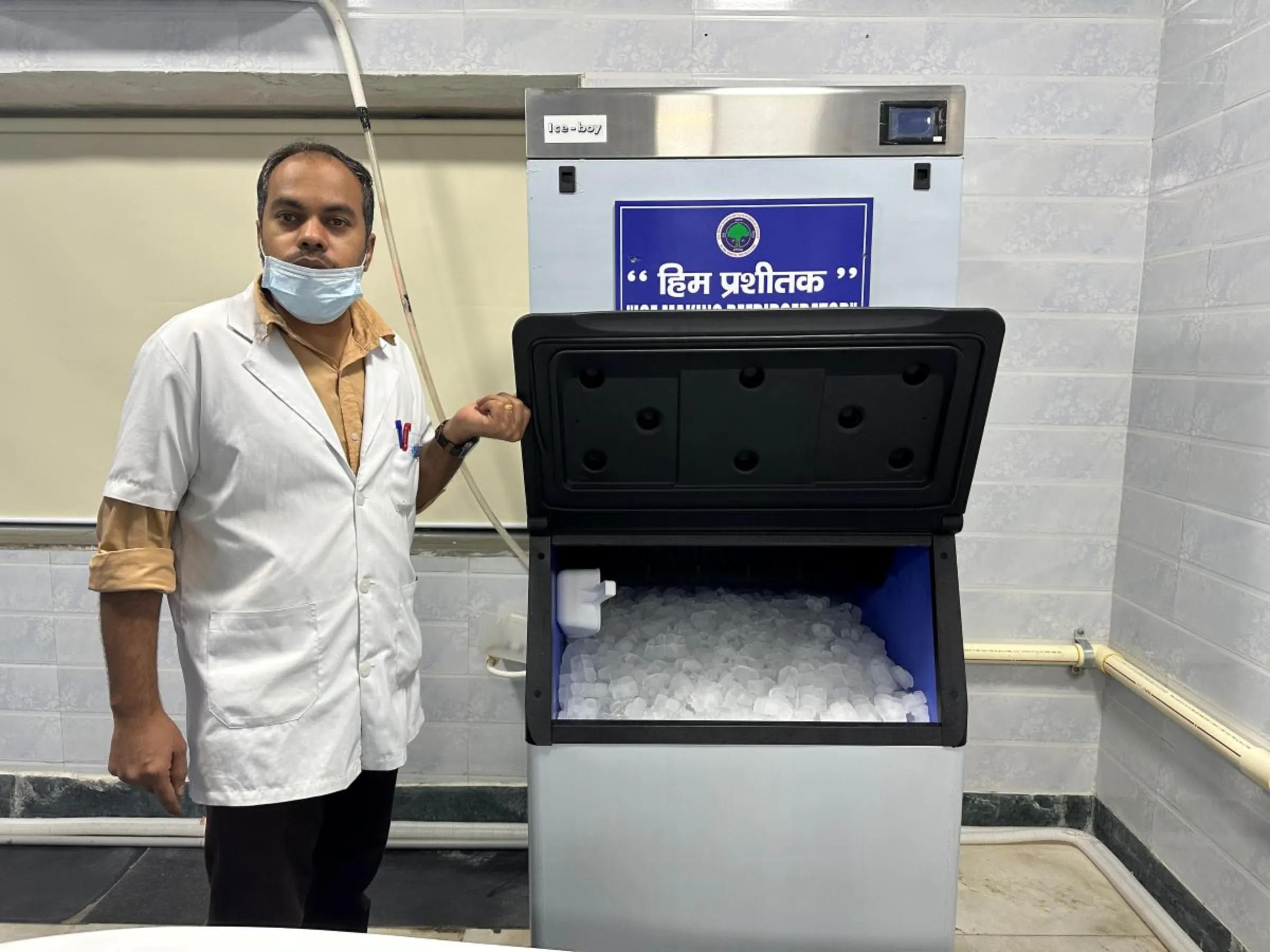 A medical attendant stands by an ice-making machine installed in the heatstroke care unit at Ram Manohar Lohia hospital in Delhi, India. June 13, 2024. Thomson Reuters Foundation/Bhasker Tripathi