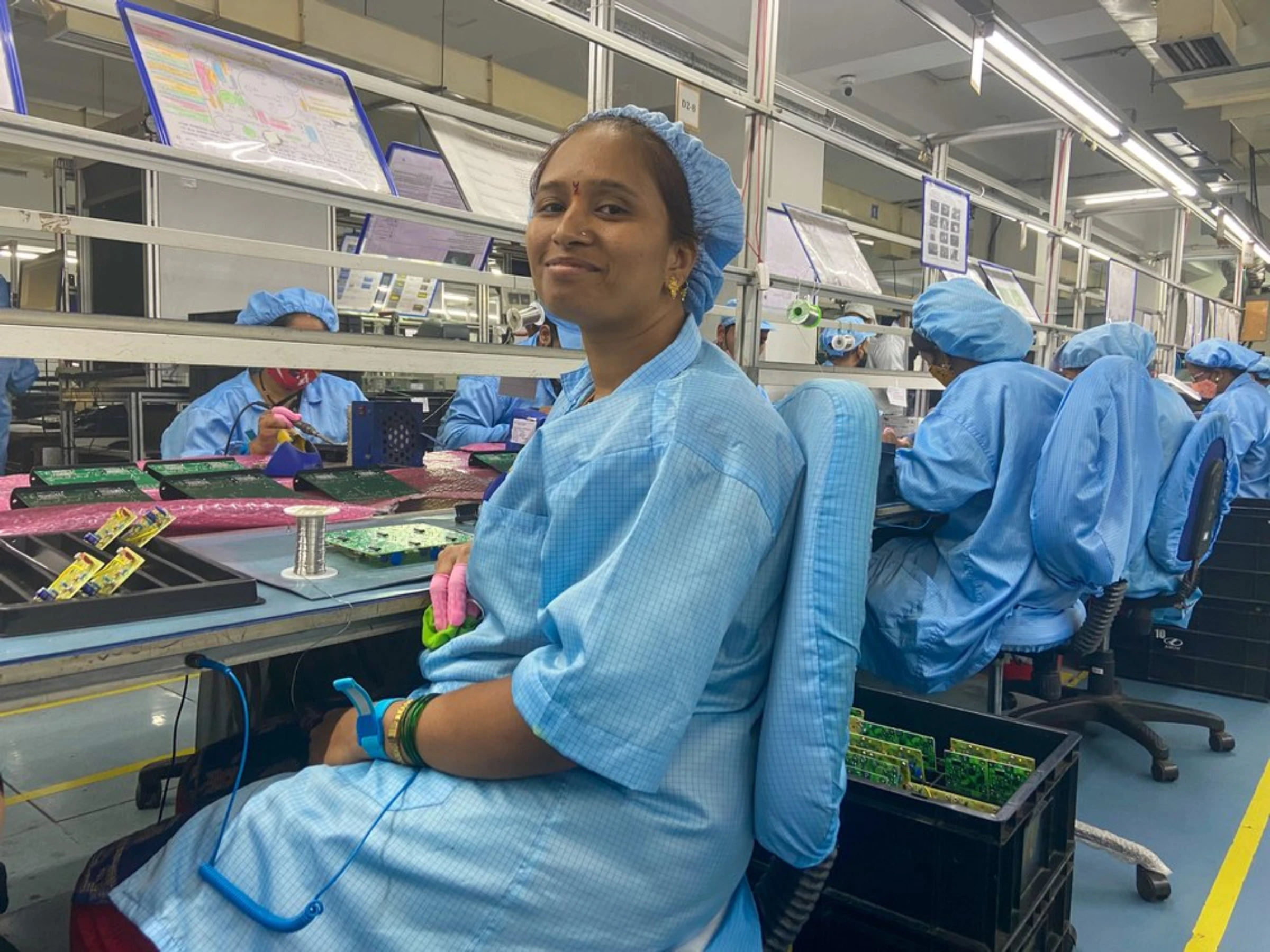 Pratibha Kumbhar poses on the Kinetic Communications factory floor in Pune, India, April 20, 2022