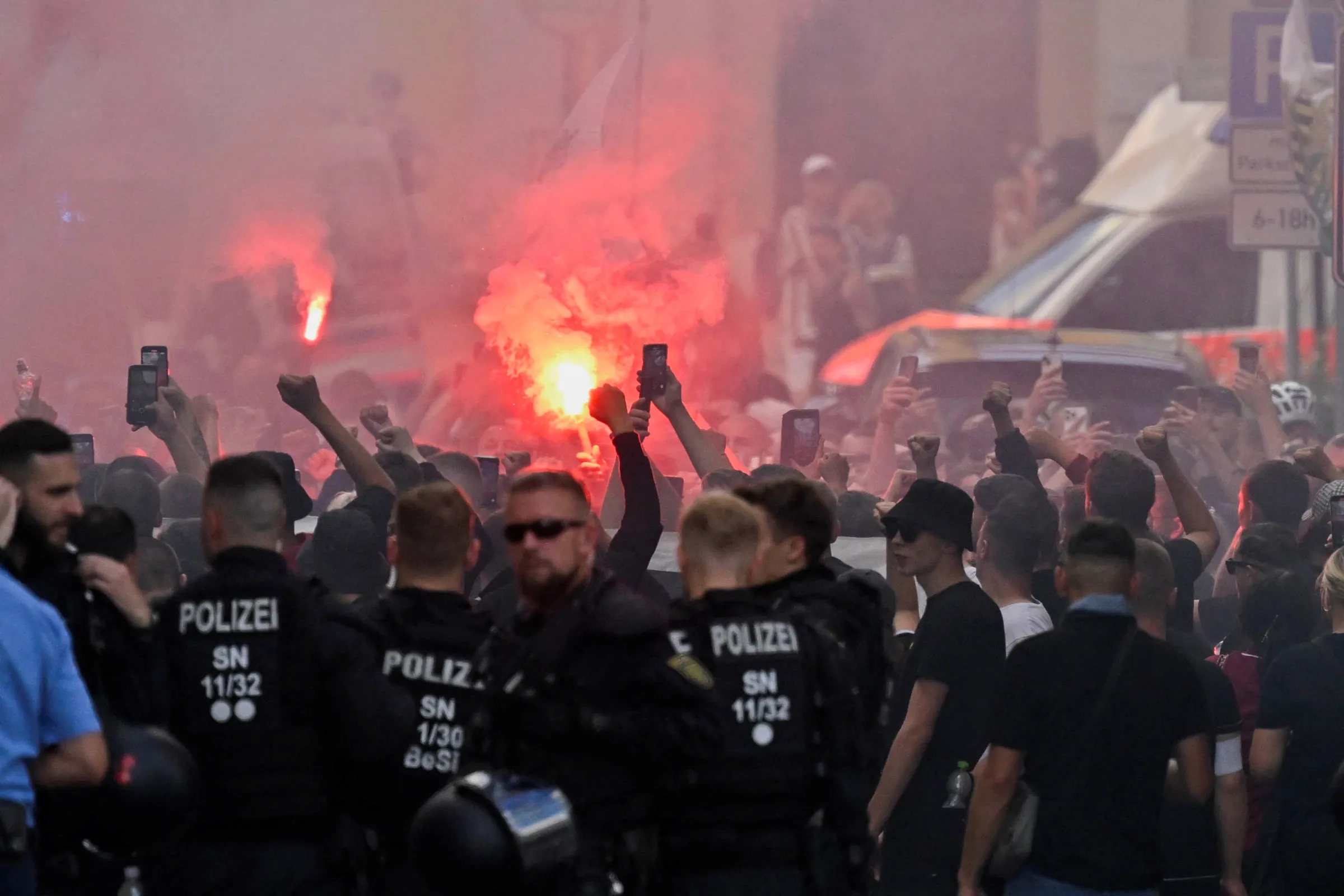 Flares burn as right-wing supporters protest during the annual Christopher Street Day (CSD) LGBTQ+ Pride march, in Bautzen, Germany August 10, 2024. REUTERS/Matthias Rietschel
