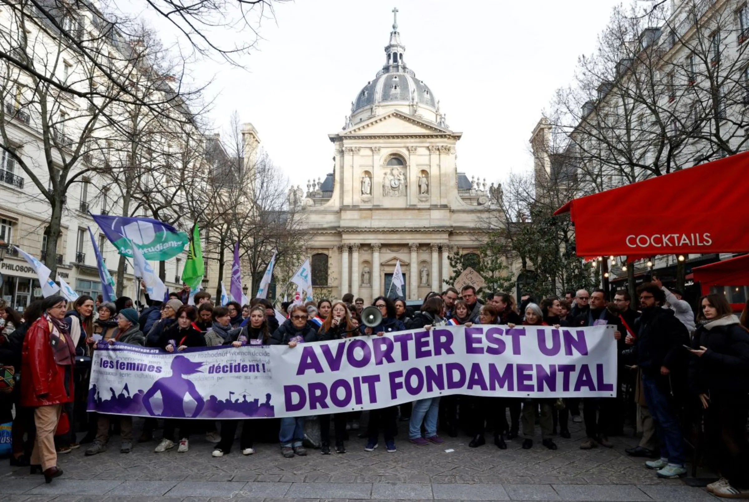 People hold a banner which reads 'Abortion is a fundamental right' during a demonstration organised by the collective 'Abortion Europe, women decide' as the French Senate examines a bill to include abortion in the Constitution, at the Place de la Sorbonne in Paris, France, February 28, 2024. REUTERS/Abdul Saboor