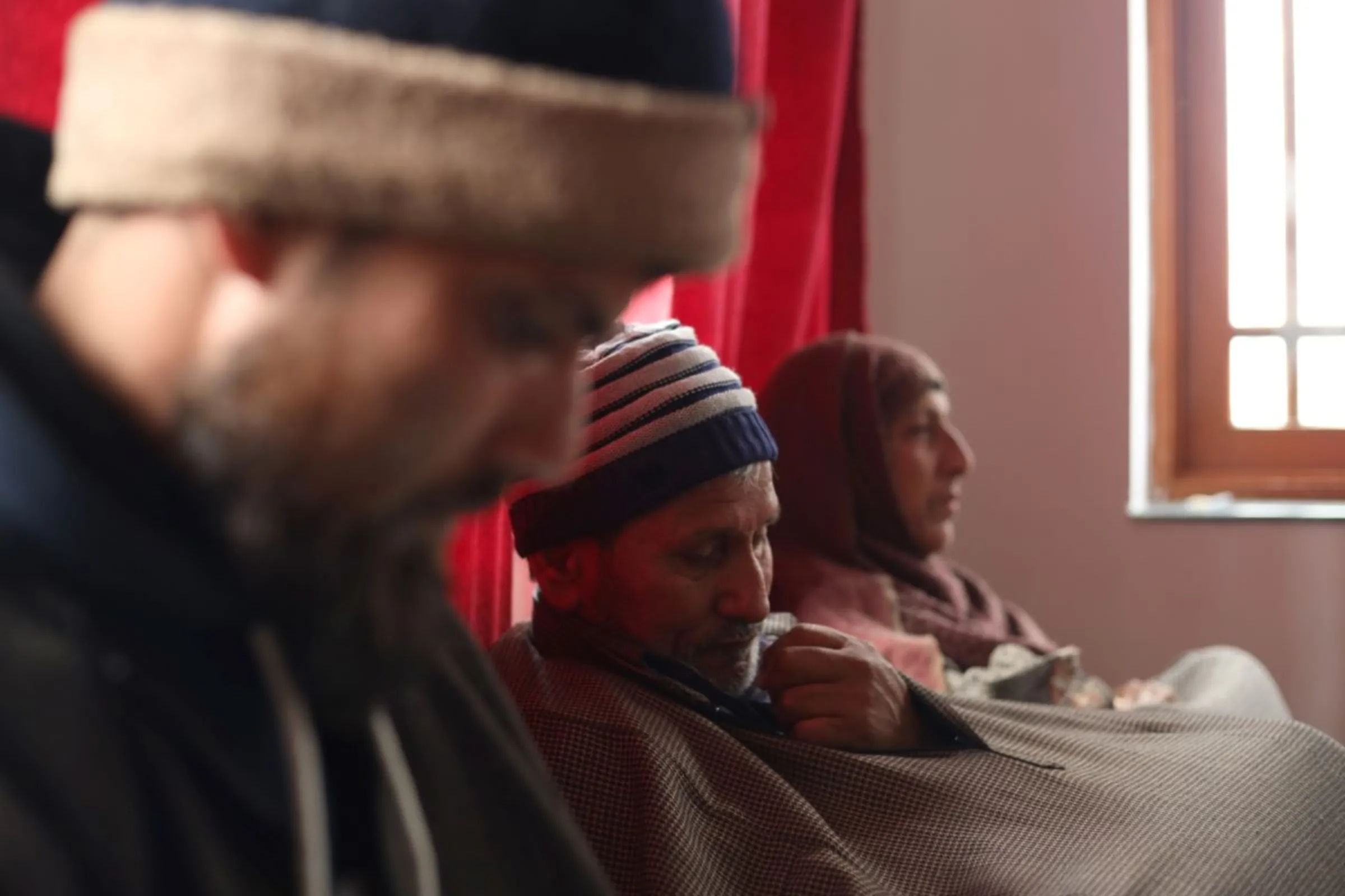Family members of Azad Yousuf Kumar, who got duped into fighting in the Russia-Ukraine war, sit at their home in Poshwan, Kashmir, Febraury 28, 2024. Thomson Reuters Foundation/Kamran Yousuf