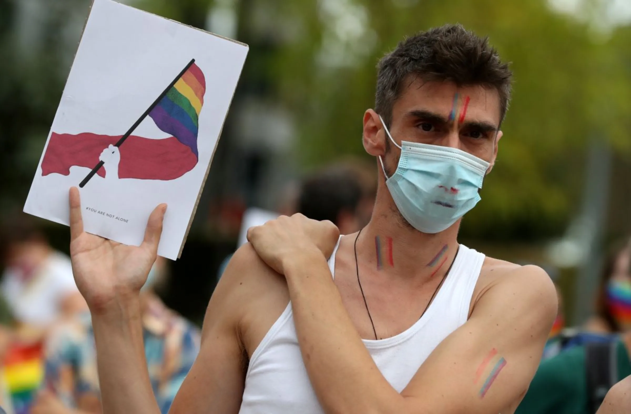 A demonstrator holds a sign as people rally in solidarity with Poland's LGBT community, in Brussels, Belgium August 19, 2020. REUTERS/Yves Herman