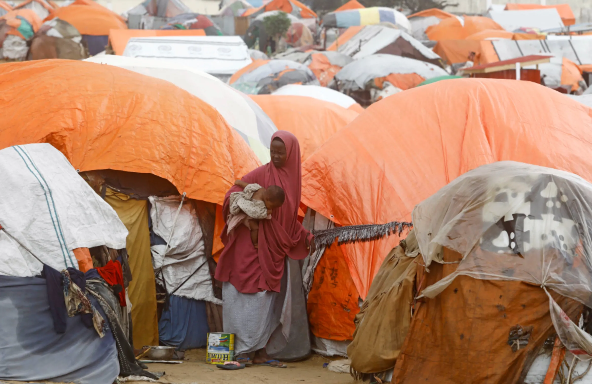 A Somali woman affected by the worsening drought due to failed rain seasons, stands outside her makeshift shelter at the Alla Futo camp for internally displaced people, in the outskirts of Mogadishu, Somalia September 23, 2022. REUTERS/Feisal Omar