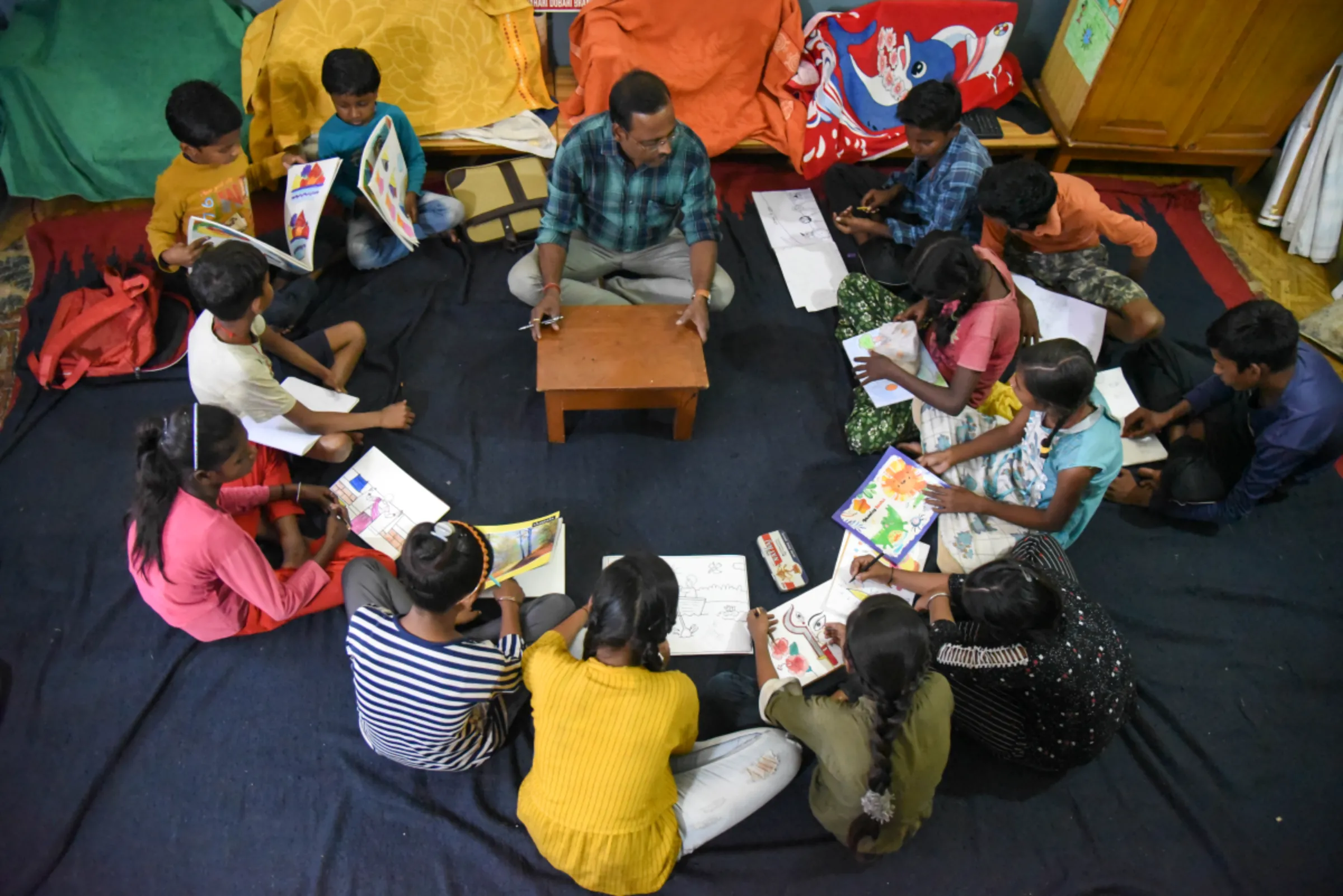 A teacher at a non-profit holds a class for children from the coalfield area of Jharia, India, November 11, 2022. Thomson Reuters Foundation/Tanmoy Bhaduri