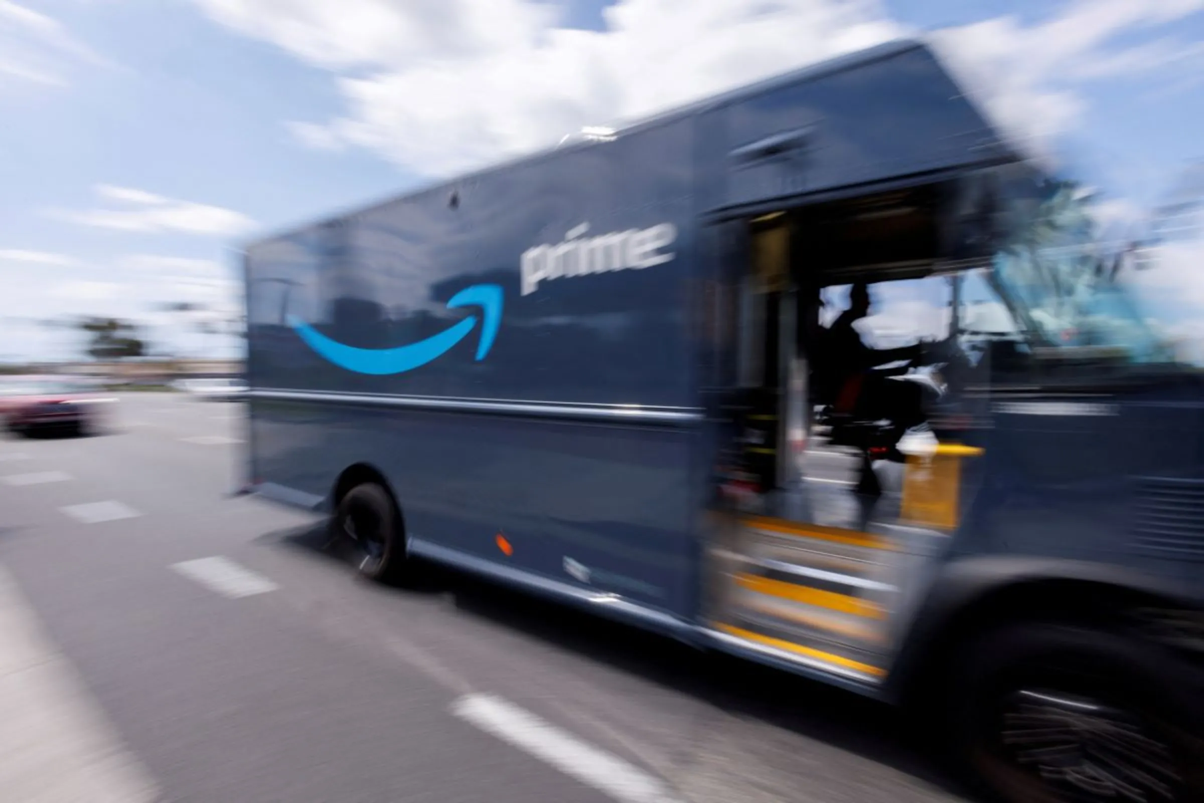 An Amazon Prime delivery van is driven along a city street in Garden Grove, California, U.S., March 29, 2022. REUTERS/Mike Blake