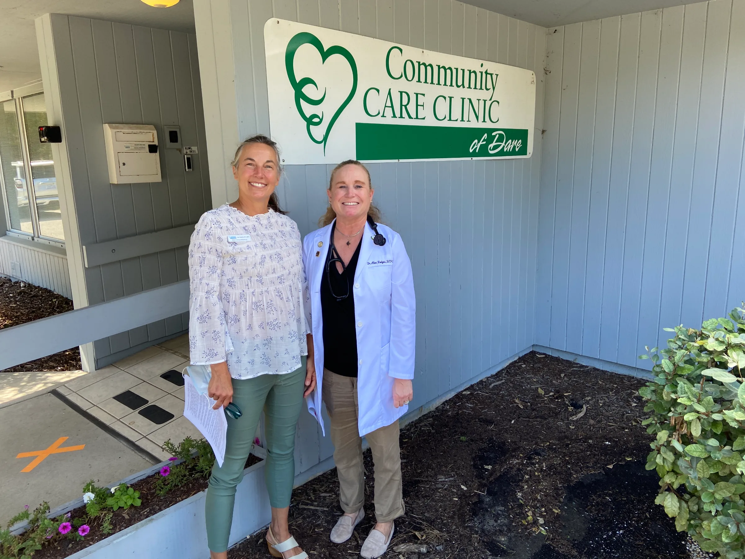 Lyn Jenkins, executive director of the Community Care Clinic of Dare (L), and nurse practitioner Alexis Hodges (R) pose for a photo outside of the clinic in Nags Head, North Carolina, USA, September 7, 2022. Thomson Reuters Foundation/David Sherfinski