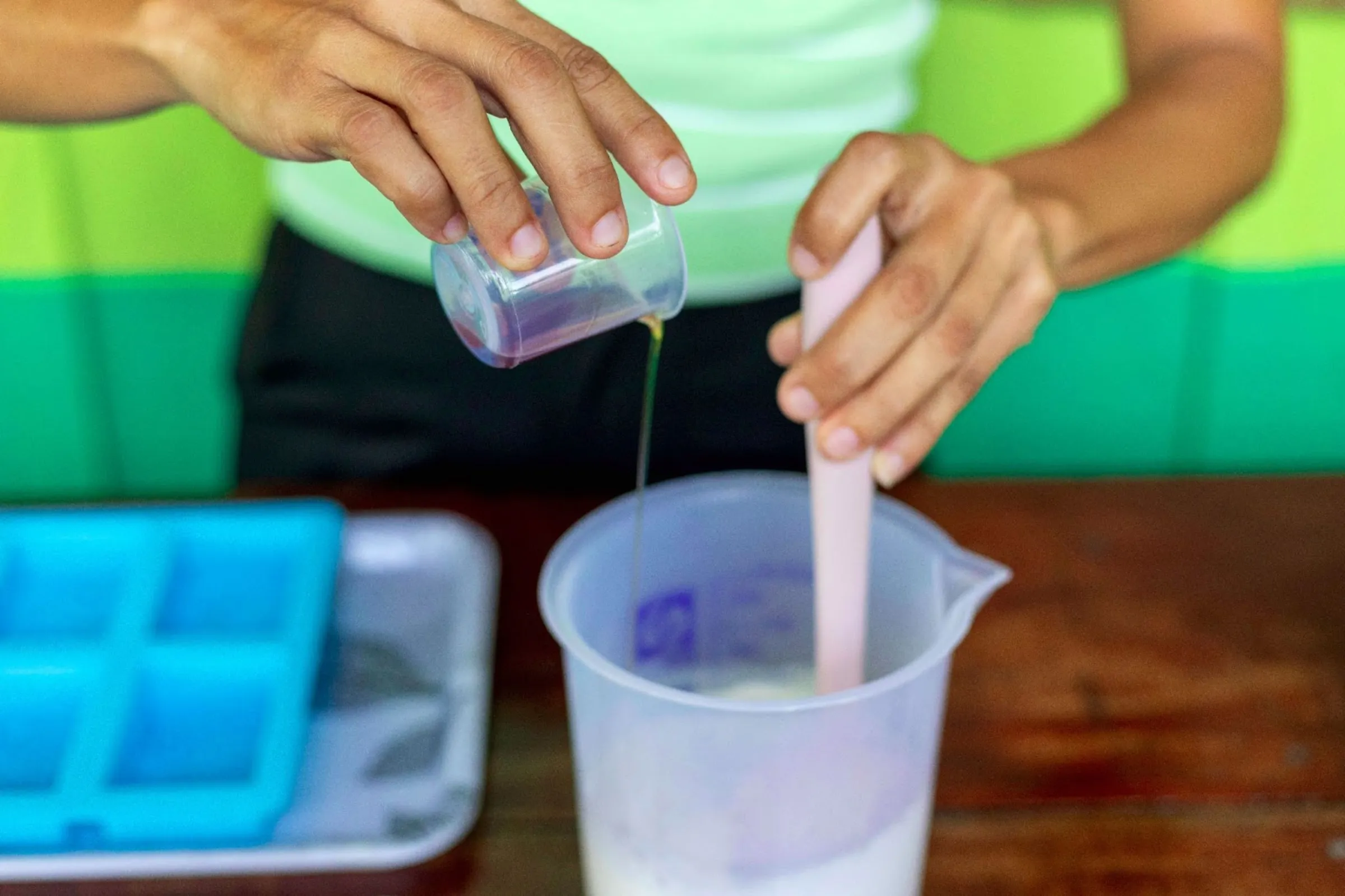 Elisângela Barbosa demonstrates the process of fabricating soap utilizing andiroba seeds, in RDS Puranga Conquista, Manaus, Brazil, March 13, 2025. Nathalie Brasil/Thomson Reuters Foundation