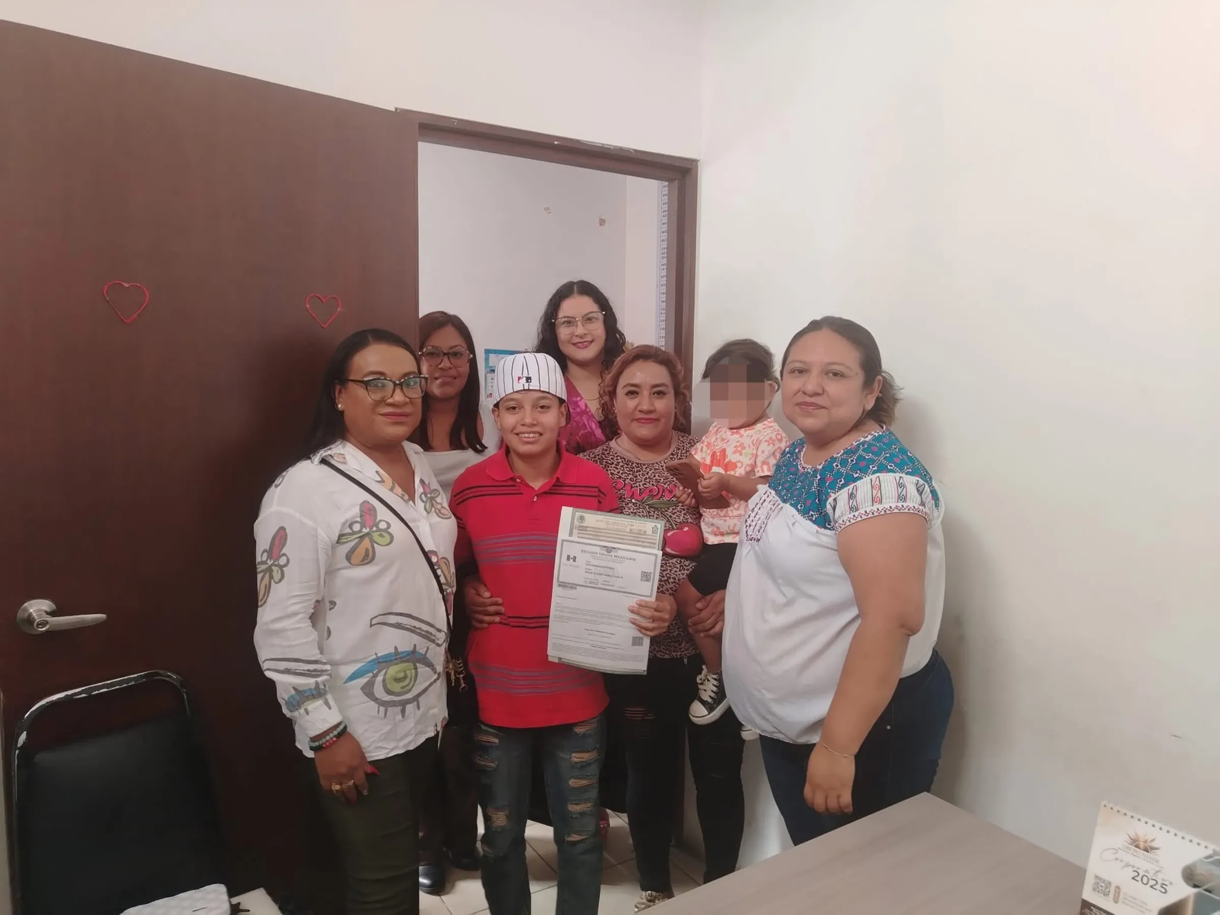 Trans teen Jessie Quiroz poses with Azul Gómez Montealegre, director of the LGBTTTIQ Collective, and his mother Brenda Quiroz, among others, in Oaxaca, Mexico, June 16, 2025. Colectivo Lgbtttiq Juntxs x Oaxaca/Handout via Thomson Reuters Foundation