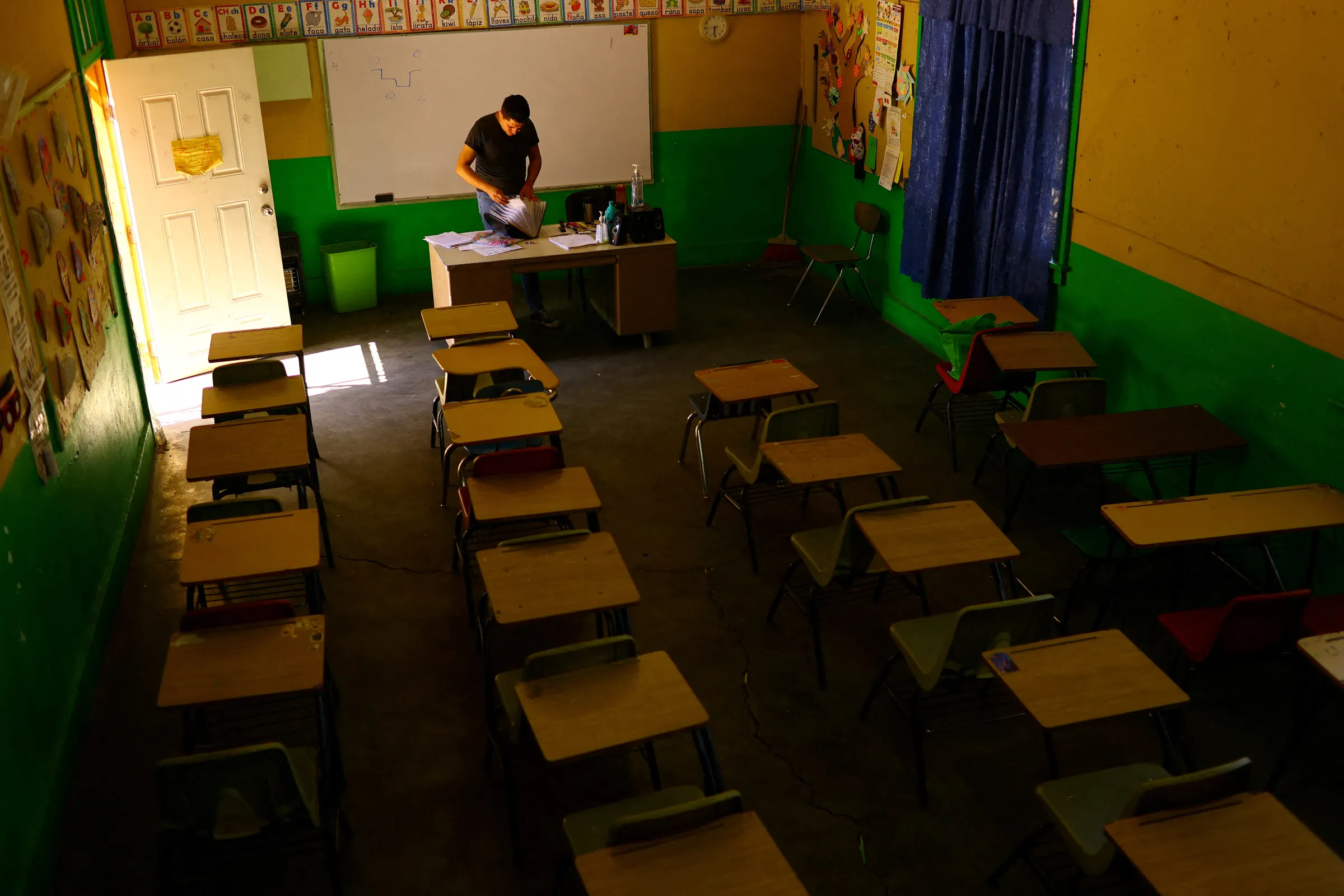 Teacher works in a classroom after the educational authorities brought forward the end of the school year for students due to high temperatures, in Ciudad Juarez, Mexico July 10, 2023. REUTERS/Jose Luis Gonzalez